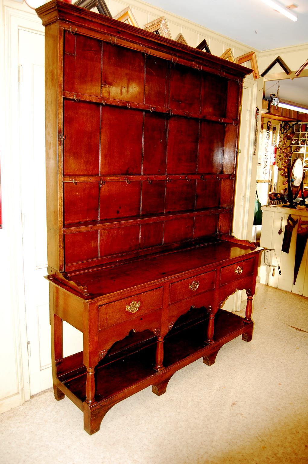 Welsh Georgian oak potboard dresser in two parts.  This full dresser has three working drawers and a lower shelf (called a potboard shelf) which would store large pots, cookware or dairy jugs.  The  pierced skirting under the drawers is nicely