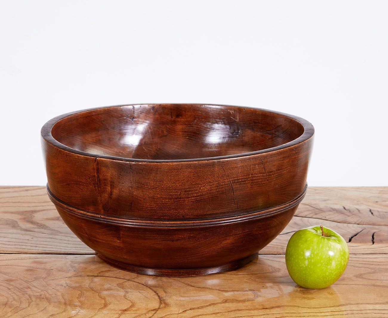 Fine early 19th century Welsh turned ash harvest bowl, having deep basin, the waist with turned band, the whole possessing good rich color and patination.