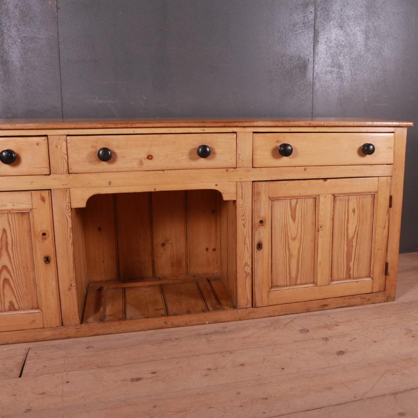 Large narrow pine dresser base with arched dog kennel, 1820.

Dimensions:
84 inches (213 cms) wide
20.5 inches (52 cms) deep
32.5 inches (83 cms) high.