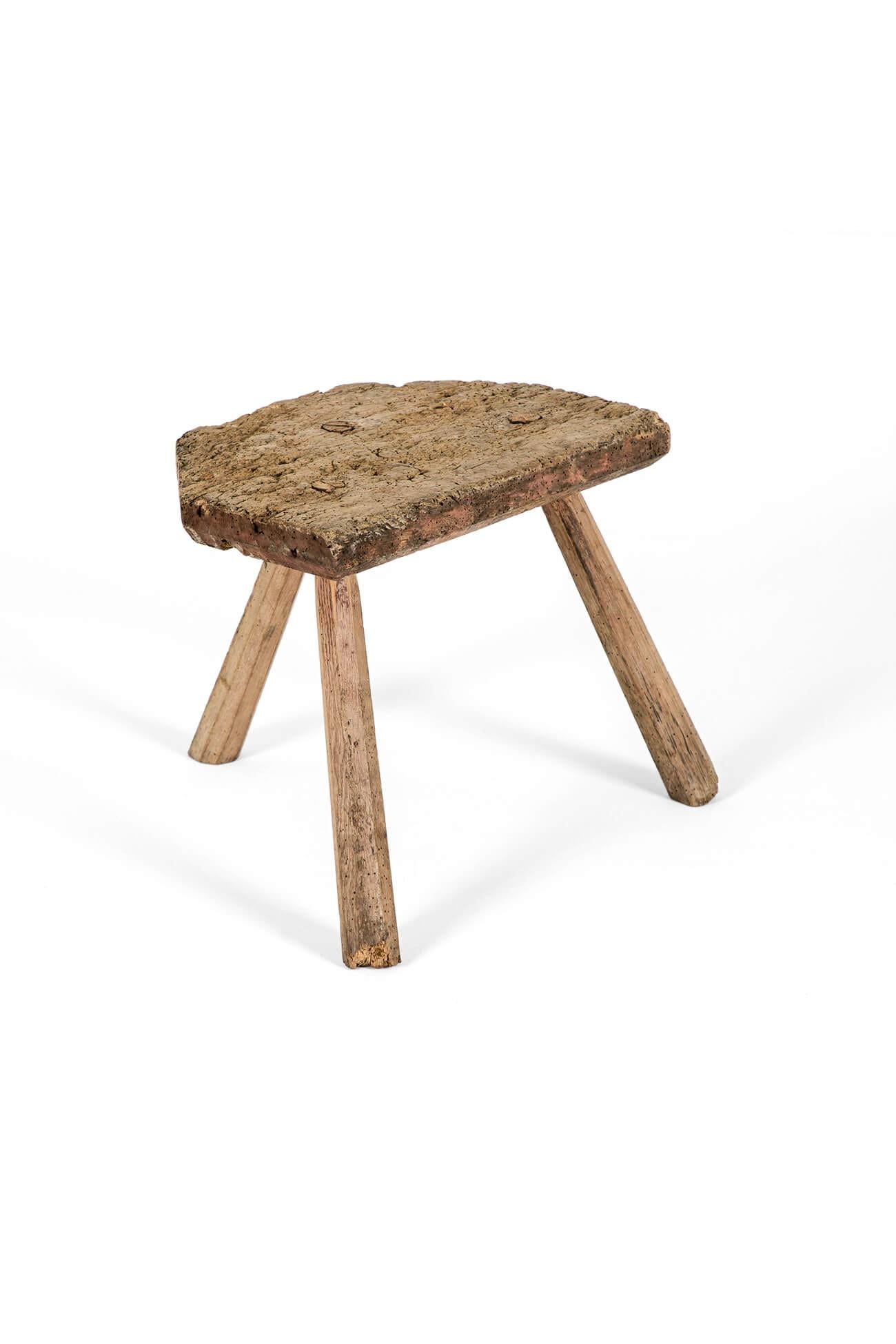 An early 19th century elm milking stool raised on three chunky pine legs.

The seat is heavily pitted with extensive wear to the surface only adding to its rustic charm.

A charming piece of Vernacular furniture from the the island of