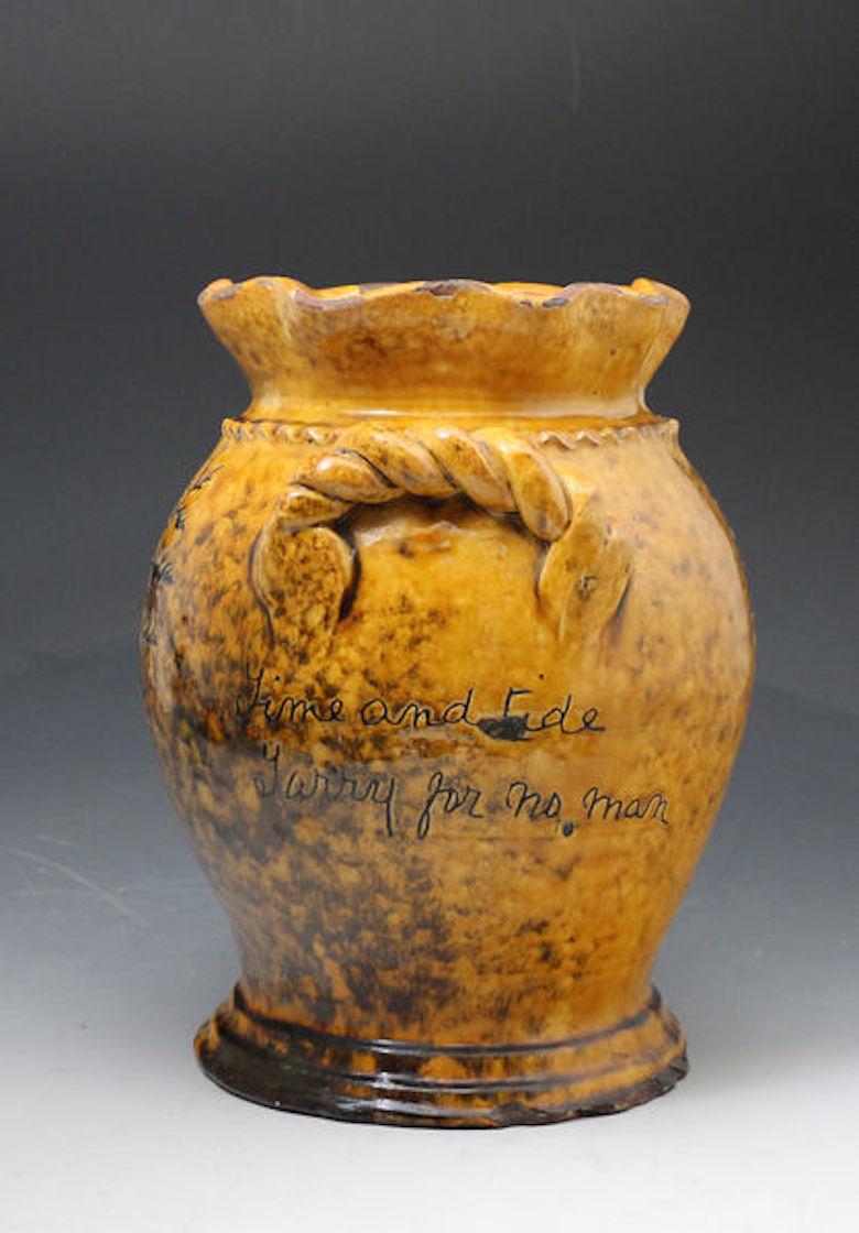 Welsh slipware earthenware vase with sgraffito sea weed decoration and an inscription in Welsh. 

A large earthenware slipware vase with rope twist handles and sgraffito decorated with seaweed and two inscriptions, 