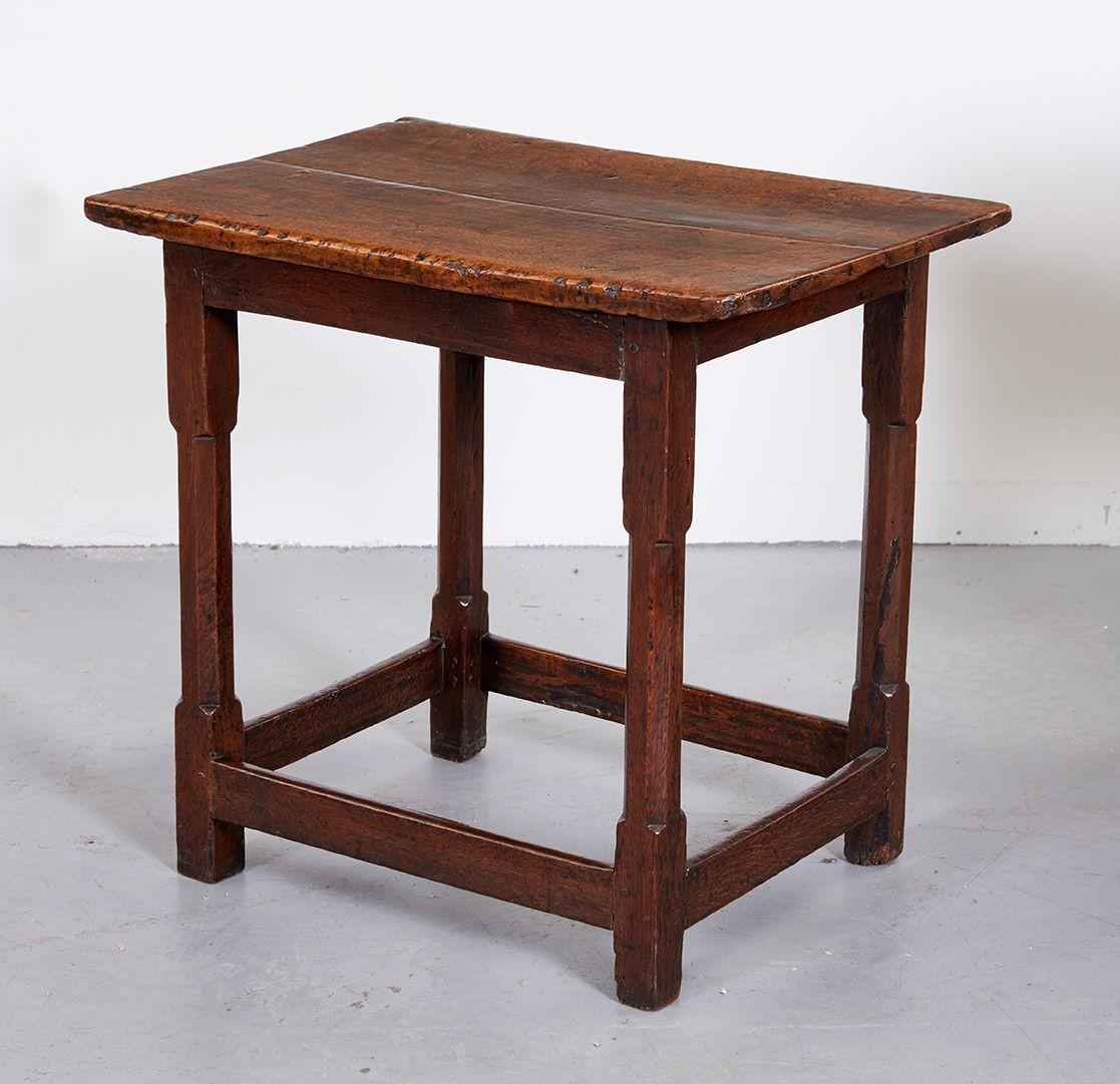 Wonderfully small scale, beautifully patinated 17th century Welsh tavern table.  Thick rectangular two plank vividly figured oak top with underbevel.  Legs with chamfering and joined by box stretcher.  Heavy weight and solid construction.  Suitable
