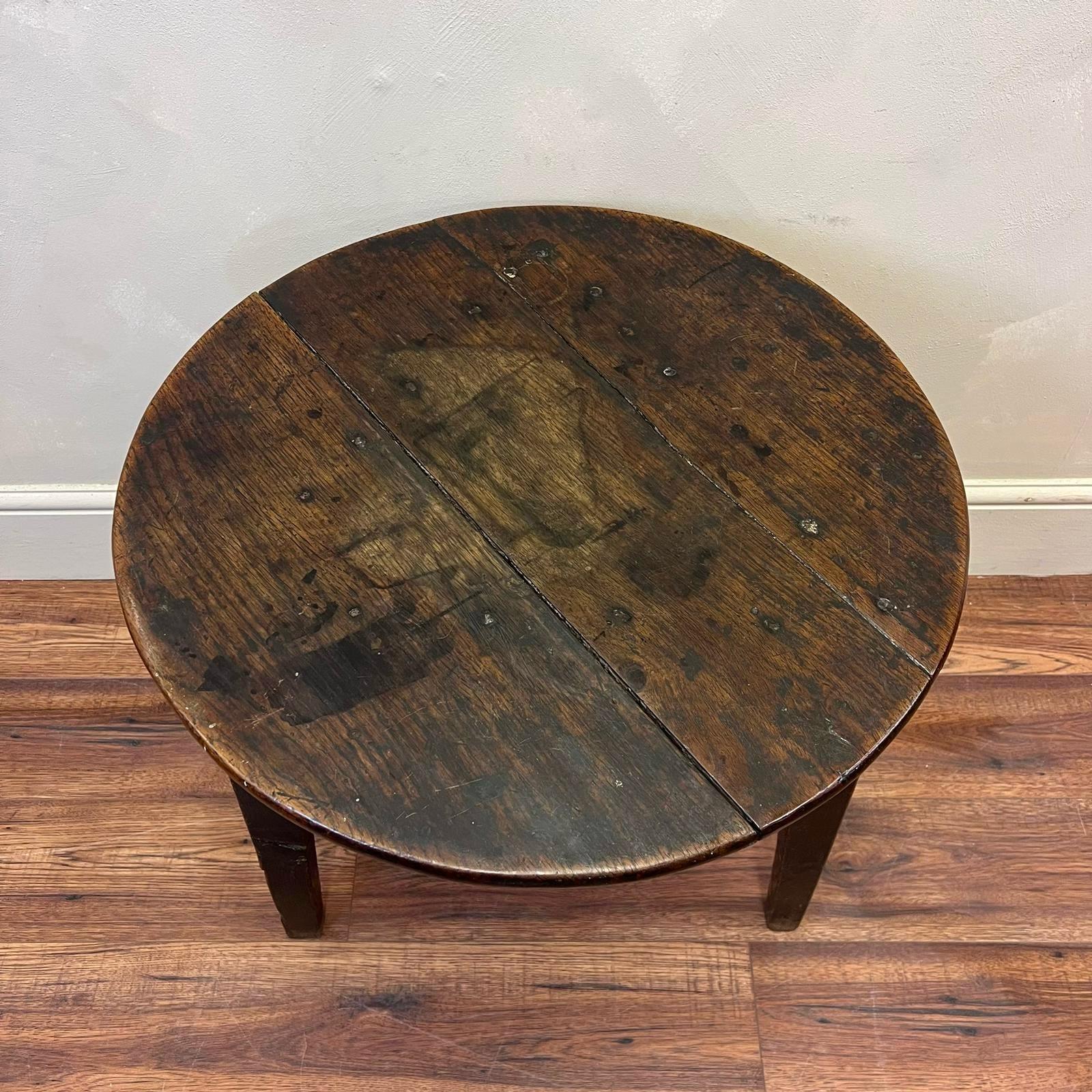 Welsh, yew and oak Cricket Table circa 1800.
With scalloped apron and original rosehead nails.
This piece has years and years of wear and old repairs as shown , but very sturdy and just is part of its  history .

Height: 58.5cm
Top Diameter: