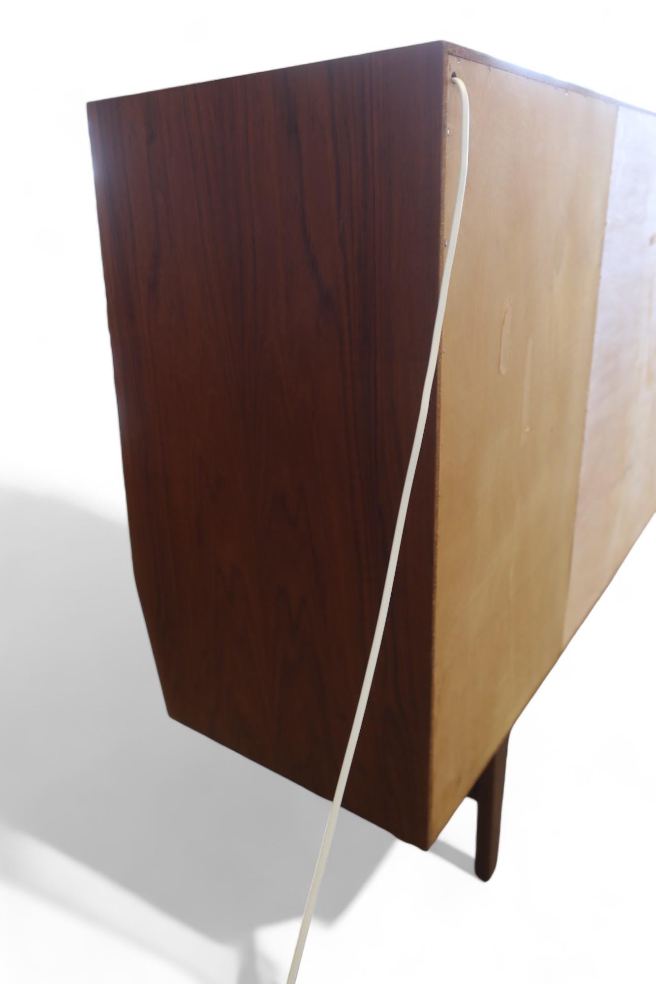 Danish Wemb Møbelfabrik sideboard in teak with illuminated bar cabinet. For Sale