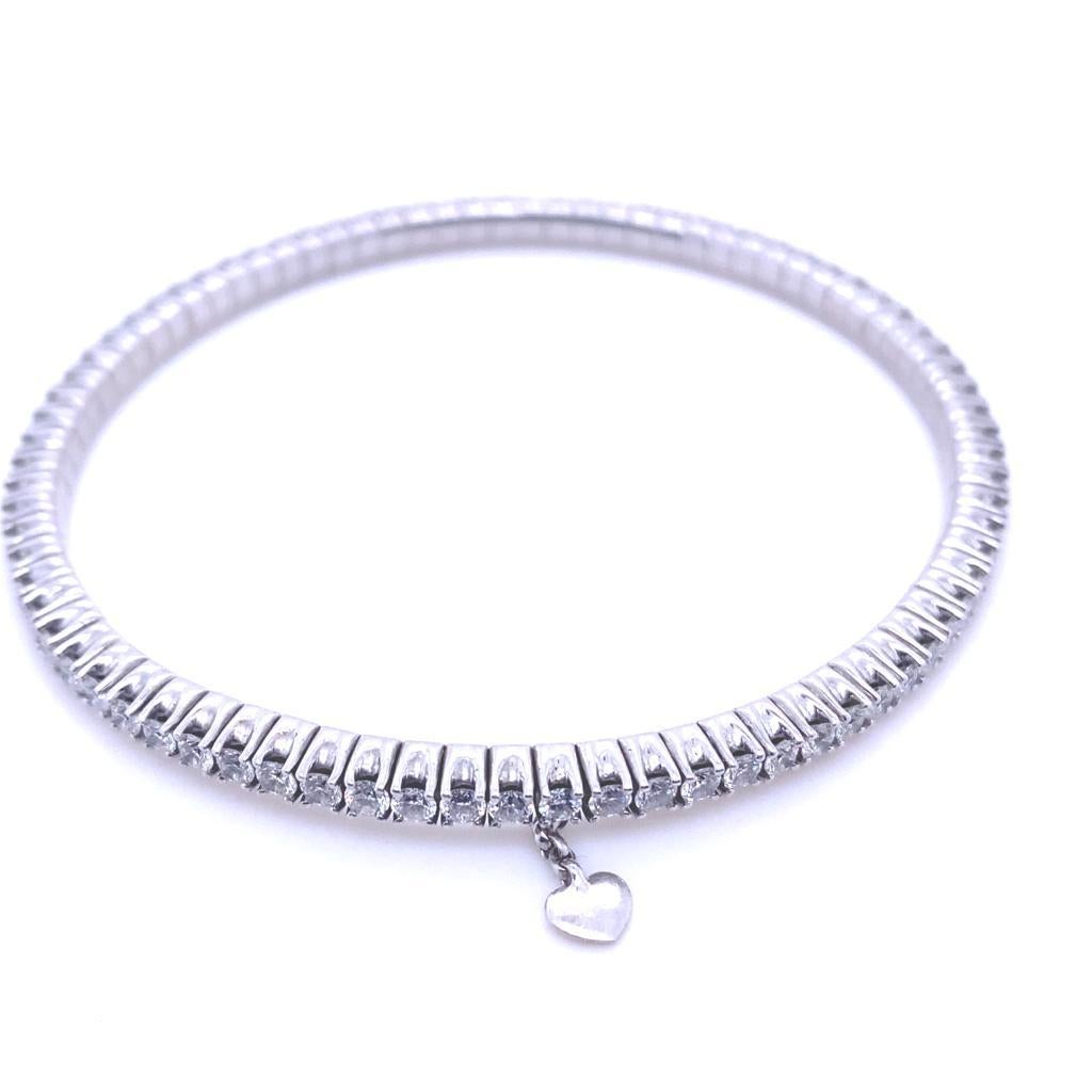 A Wempe 18 karat white gold diamond bracelet

This elegant bracelet is semi-flexible and maintains its circular shape, designed without a clasp so that it slips onto the wrist of the wearer and featuring a sweet white gold mini heart