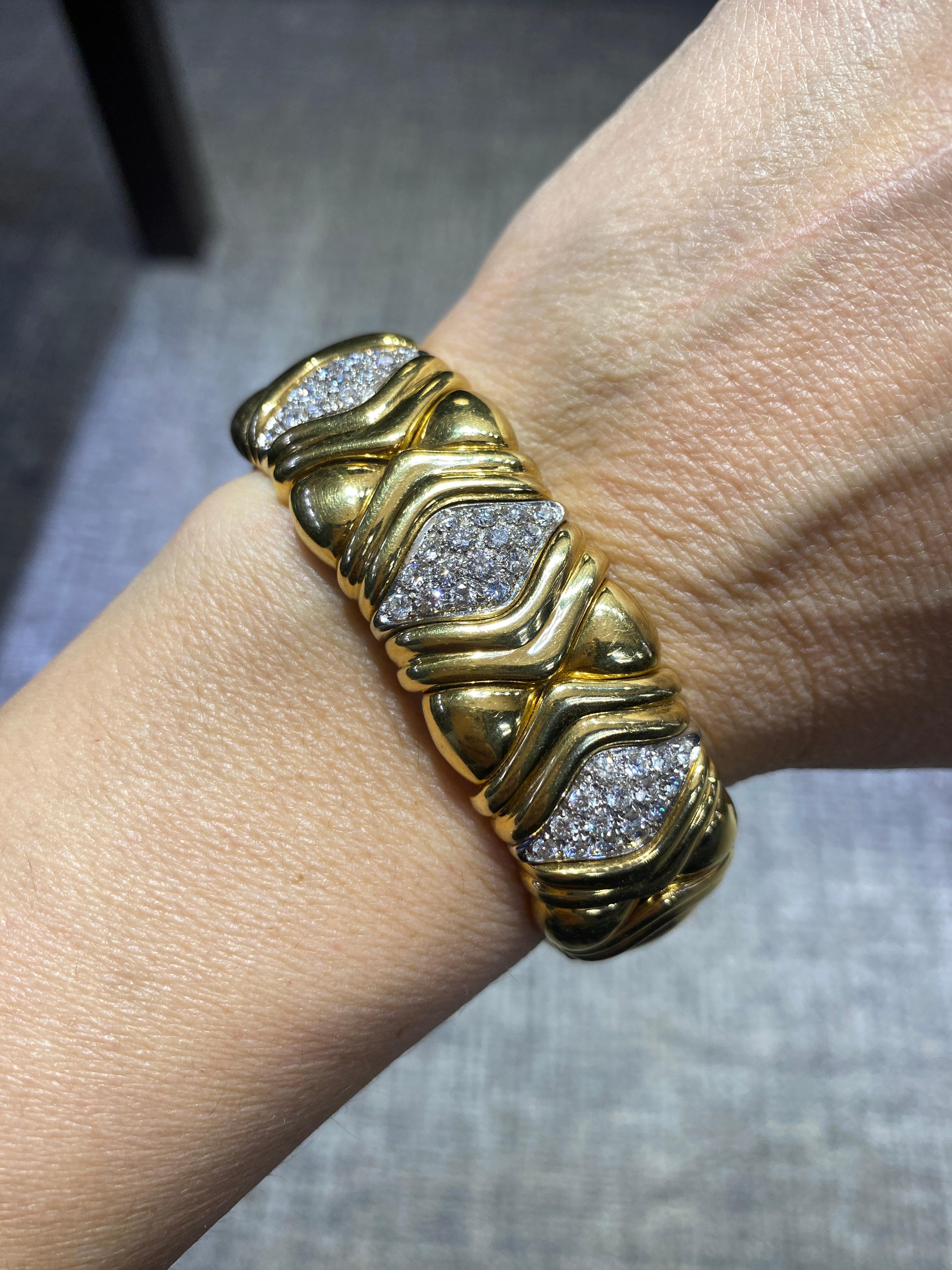 This 1980s Wempe gold and diamond cuff is a hefty piece and very comfortable to wear. It expands to let in the wrist and sits snuggly around it. It is a beautifully made piece. 