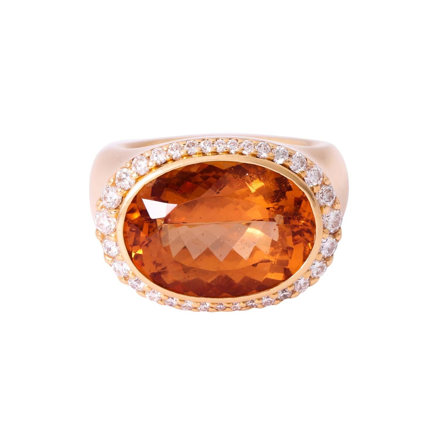 Surrounded by 32 brilliant-cut diamonds totaling approx. 1.0 ct, good color and clarity, GG 18K, 34.6g, RW: 55, 21st century, slight signs of wear, stone slightly rubbed, high-quality goldsmith's work.

 WEMPE ring with with fine imperial topaz