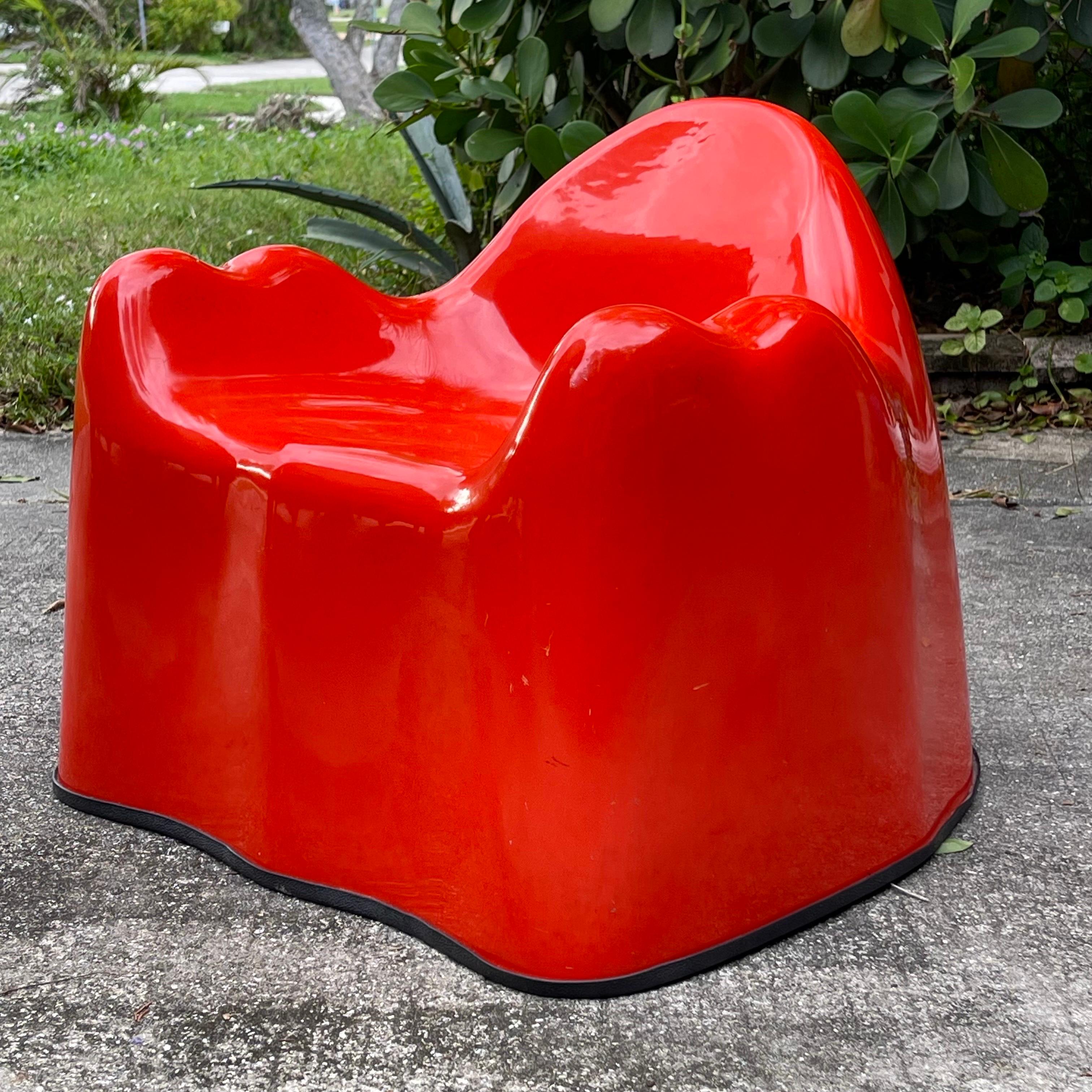 Uncommon child’s size version of Wendell Castle’s iconic Molar chair. Executed in fiberglass and red gel coat. Sprite can shown for scale.