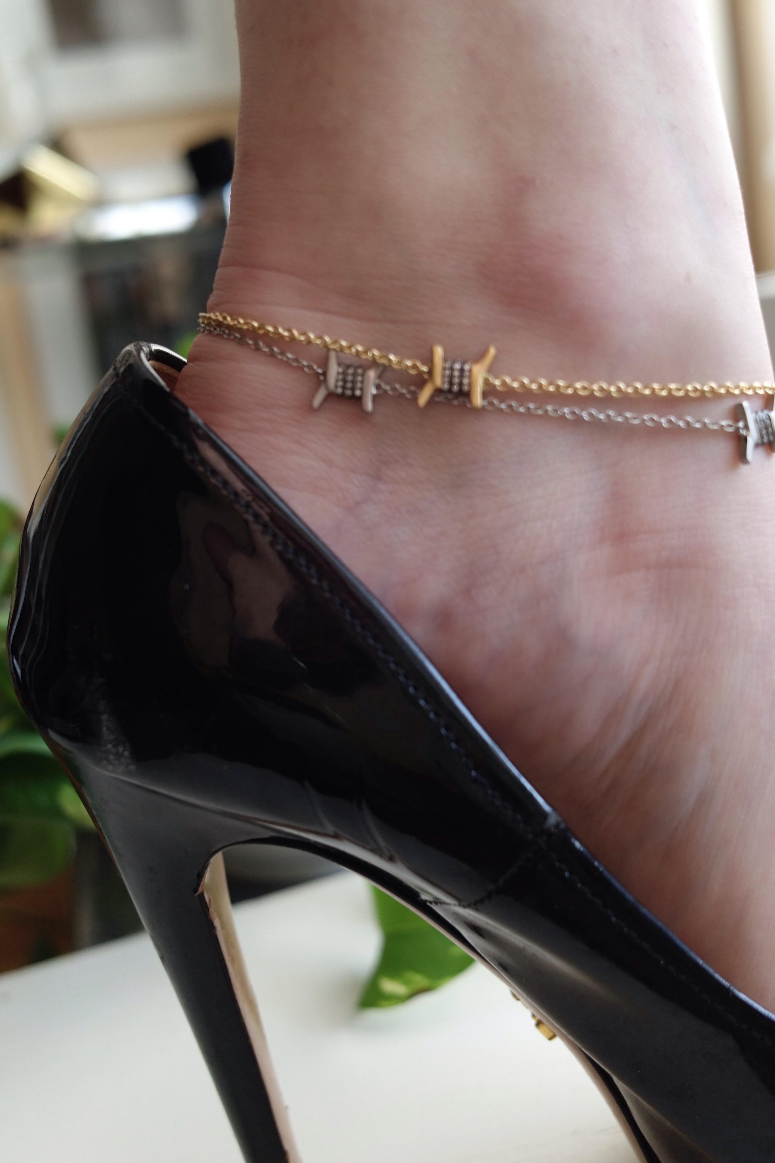 Nothing is sexier than a delicate gold chain on your ankle. This one brings some edginess to the look with its barbed-wire motif.

18K yellow gold, satin finish.
48 diamond rounds totaling 0.16 carats (E/F, VS1/VS2).
9 1/2
