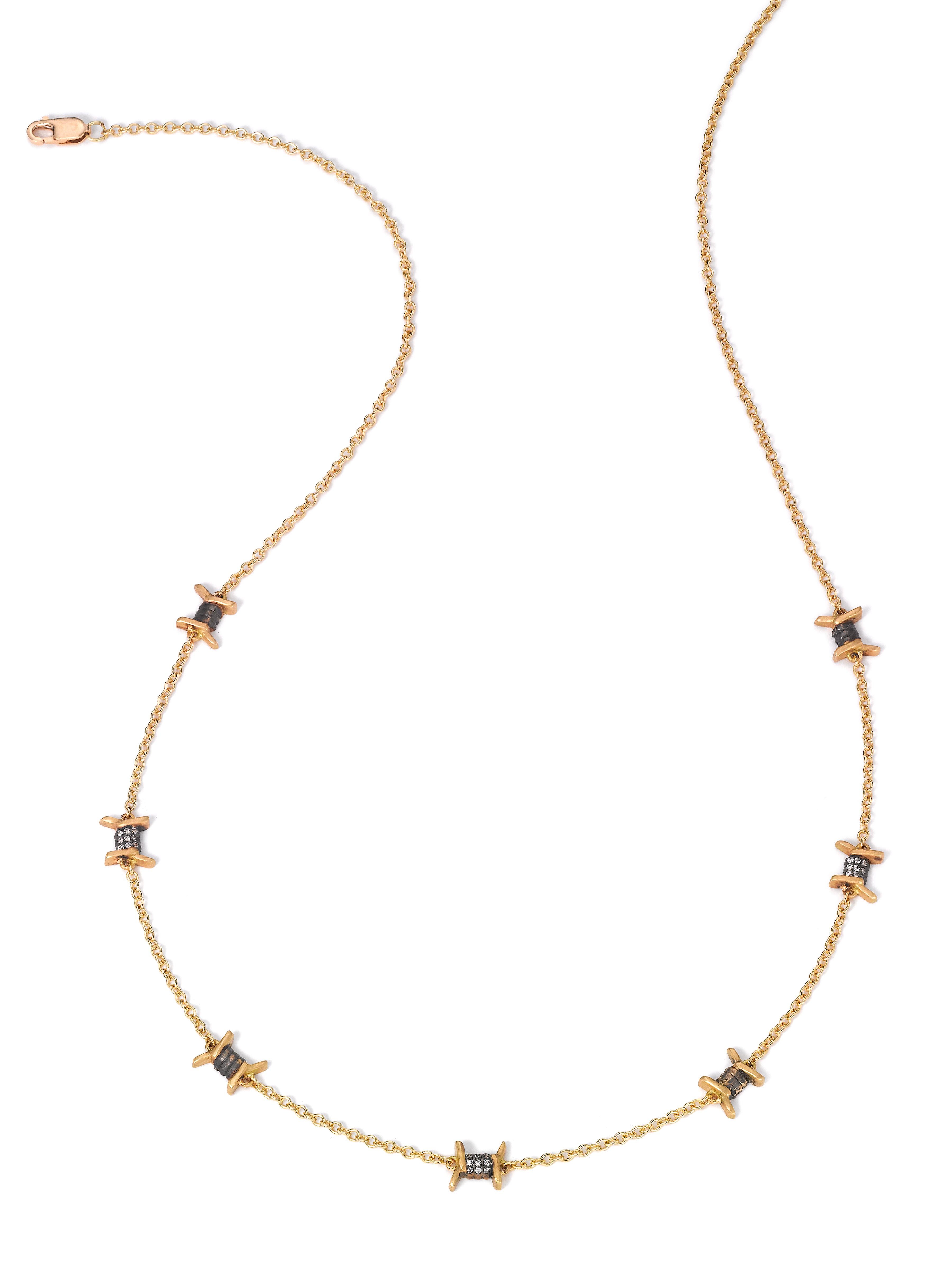 An easy necklace for everyday wear, but with a touch of punk.

18K yellow gold, satin finish.
27 diamond rounds totaling 0.09 carats (E/F, VS1/VS2).
16