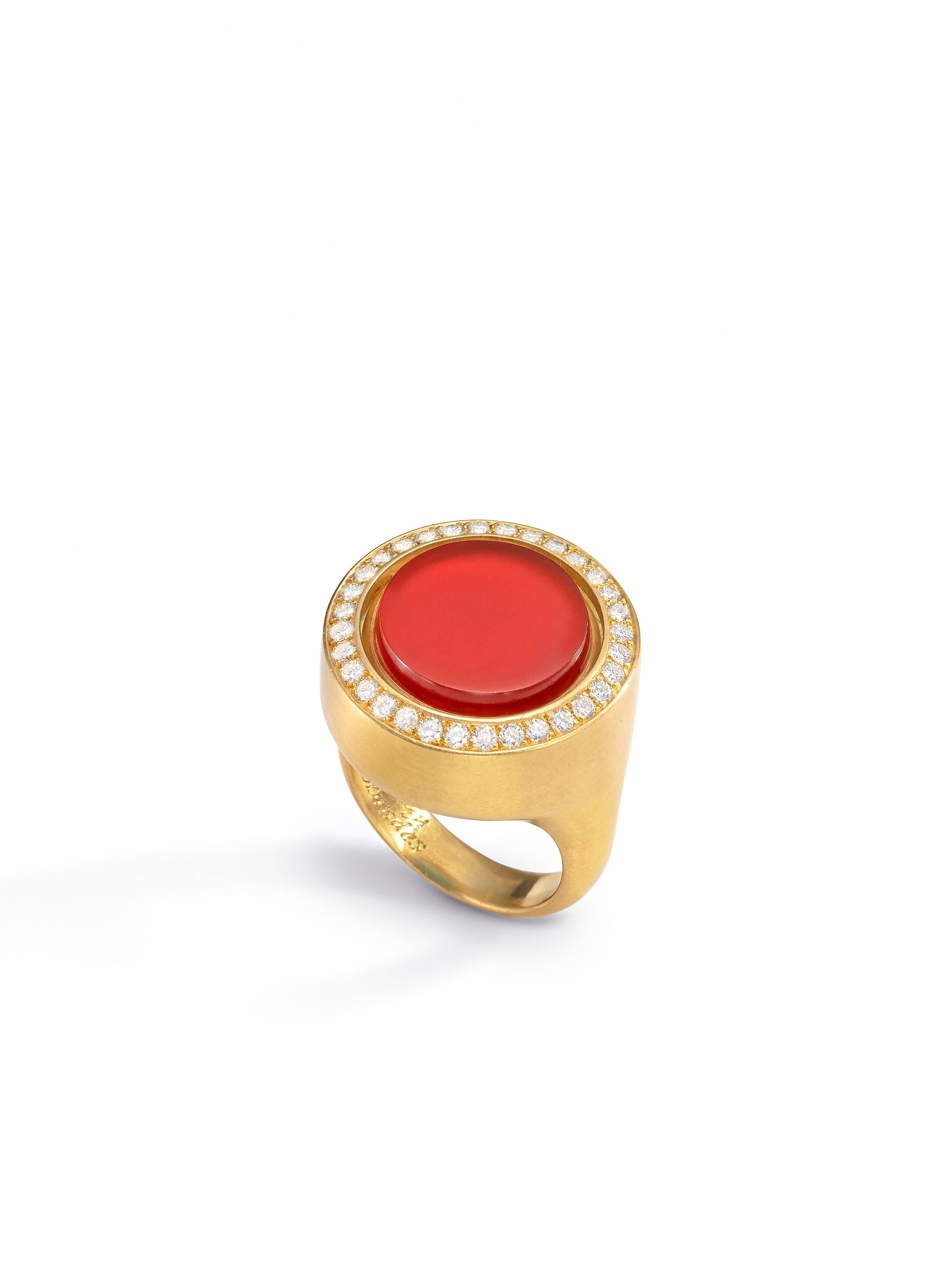 Swivel ring with turquoise center that flips over to reveal carnelian on the opposite side.
18K yellow gold, satin finish.
Diamond accents.
Size 6.
One-of-a-kind.
Made in New York City.
For a high-resolution video of this piece, please visit our