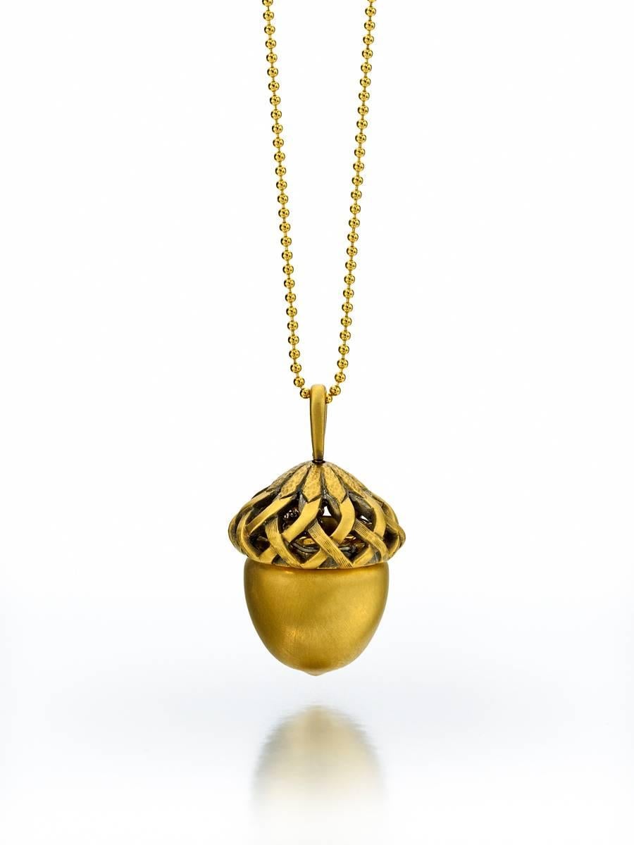 Acorn top untwists to reveal tiny squirrel.
18K yellow gold, satin finish.
26