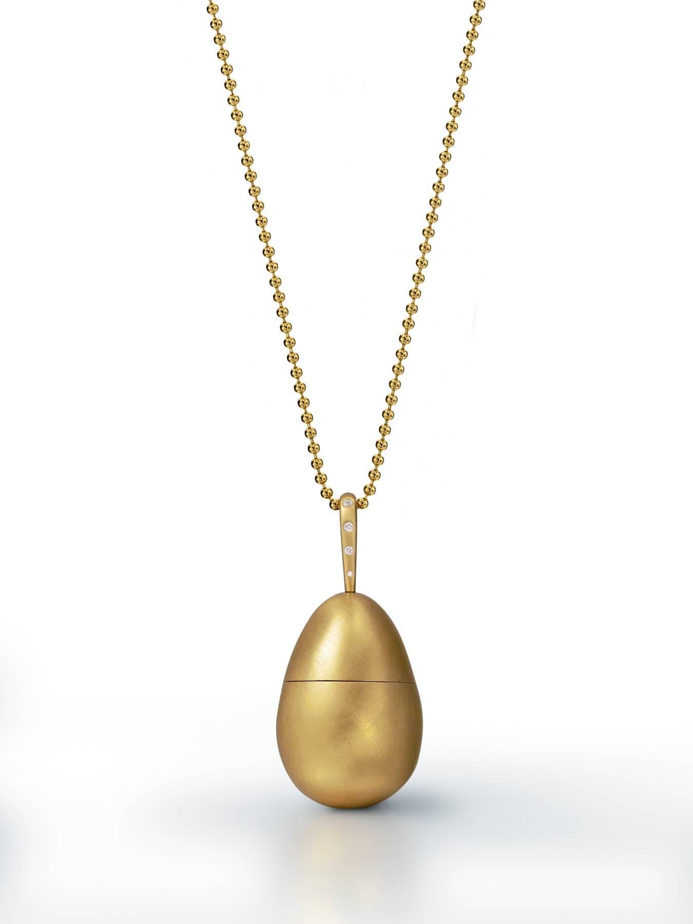 Egg opens up to reveal a silver chicken with diamond eyes.
Chicken opens up to reveal three golden eggs.
22.5 grams of 18k yellow gold, satin finish.
9 points of diamonds.
28” ball chain.
Limited edition, number 2 of 5.
Made in New York City.
For a