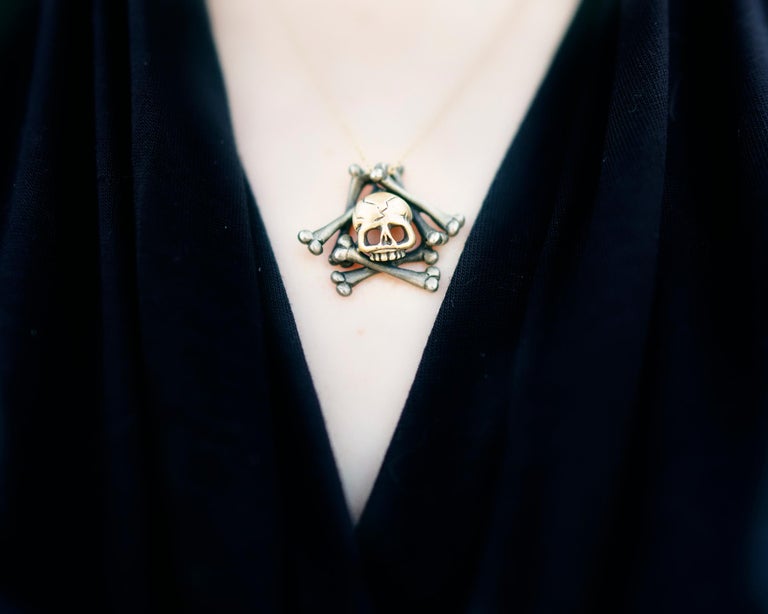 Skull imagery has long been used in memento mori jewelry. The Latin phrase 