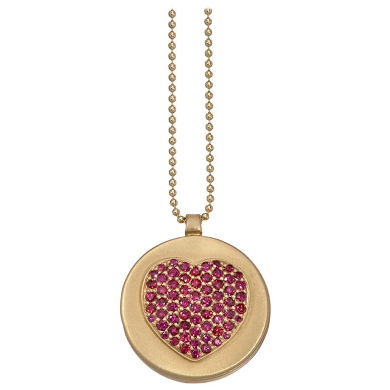 Locket necklace opens and closes. Inside of the locket is a ruby-eyed skull.
18K yellow gold, satin finish.
Rubies form a beautiful heart shape.
16
