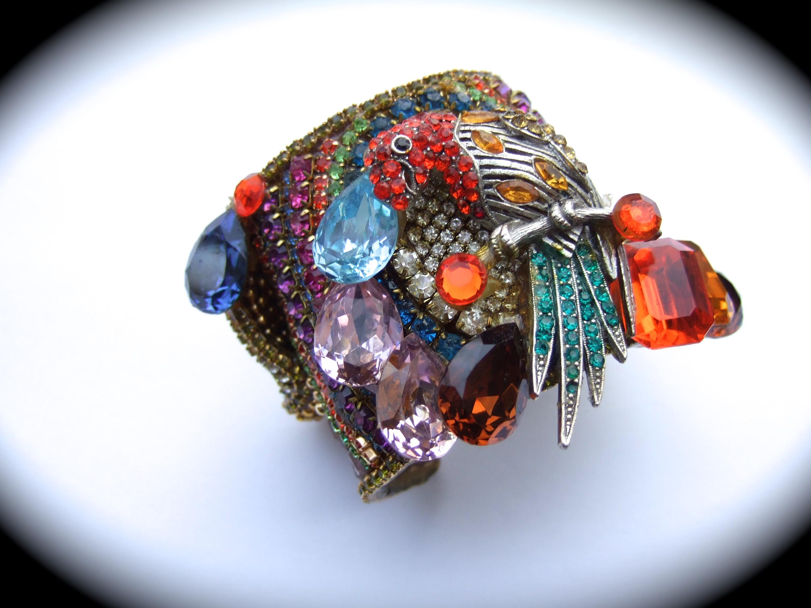 Wendy Gell Massive crystal encrusted parrot design artisan cuff bracelet c 1980s
The bold large-scale heavy brass metal cuff is embellished with a myriad of glittering 
crystals in various colors & sizes 

The jeweled parrot is perched upon a silver