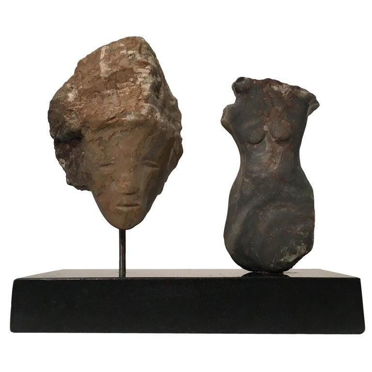 Contemporary American sculptor Wendy Hendelman's alabaster head and torso sculpture on marble base. Hendelman’s work reflects her love of the primitive and the ancient. The small scale and style have established her identity as a sculptor as was