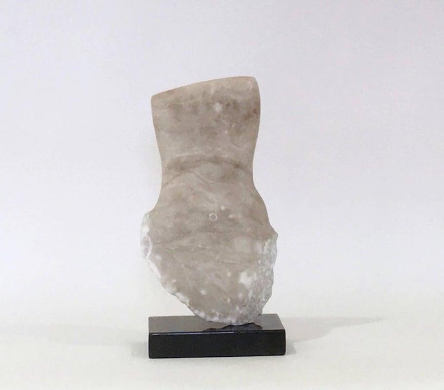 Contemporary American sculptor Wendy Hendelman's alabaster torso sculpture on a marble base. Hendelman’s work reflects her love of the primitive and the ancient. The small scale and style have established her identity as a sculptor as was recognized