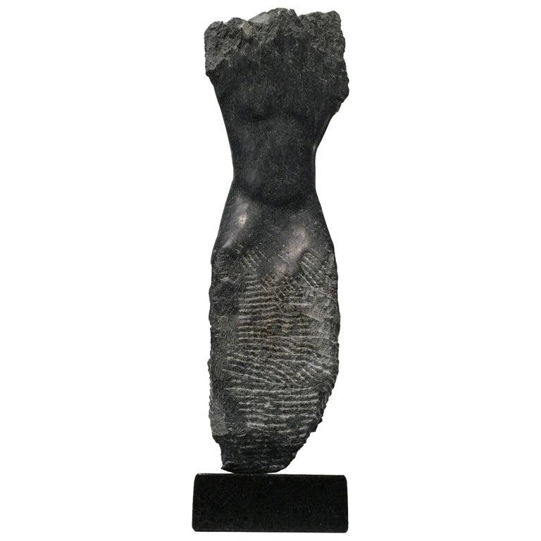 Contemporary American sculptor Wendy Hendelman's black Alabaster Torso sculpture on a black marble base. Hendelman’s work reflects her love of the primitive and the ancient. The small scale and style have established her identity as a sculptor as