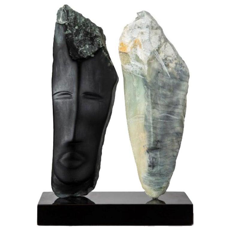 Contemporary American sculptor Wendy Hendelman's black and green Alabaster heads sculpture on black marble base. The small scale and style have established her identity as a sculptor as was recognized in the following press release by a Parisian art