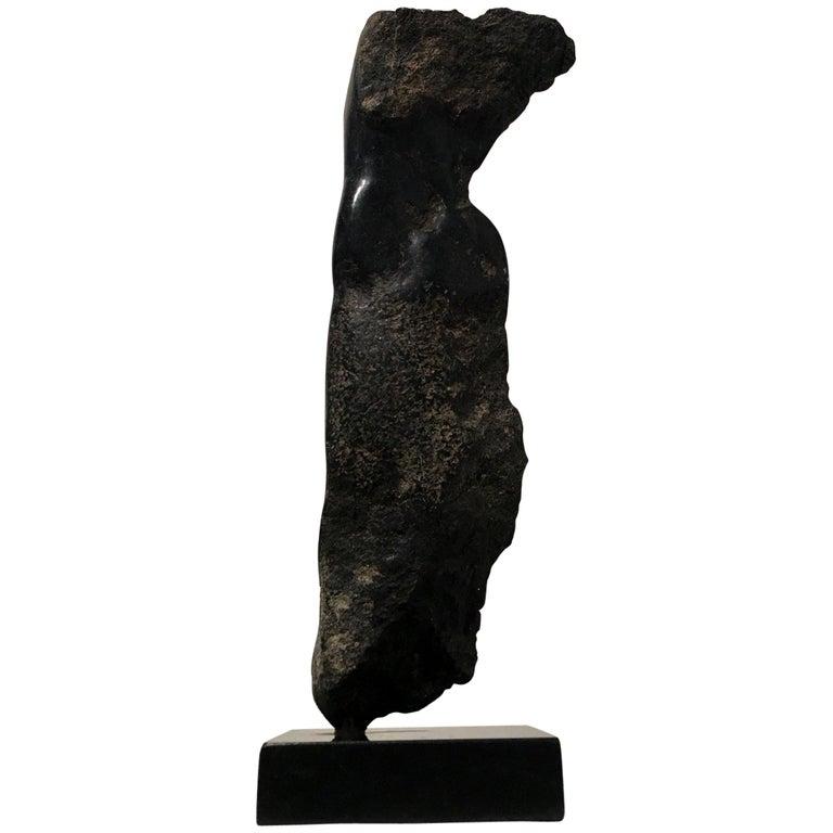 Contemporary American sculptor Wendy Hendelman's cast bronze Torso sculpture on a black marble base. Hendelman’s work reflects her love of the primitive and the ancient. The small scale and style have established her identity as a sculptor as was