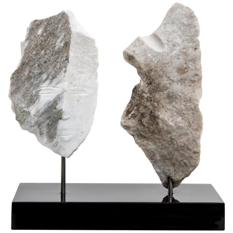 Contemporary American sculptor Wendy Hendelman's Marble Head and Torso Sculpture on a black marble base. Hendelman’s work reflects her love of the primitive and the ancient. The small scale and style have established her identity as a sculptor as