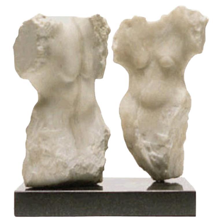 Contemporary American sculptor Wendy Hendelman's creamy white Marble Torsos Sculpture on black marble base. Hendelman’s work reflects her love of the Primitive and the ancient. The small scale and style have established her identity as a sculptor as