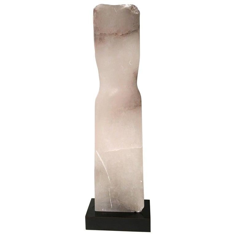 Contemporary American sculptor Wendy Hendelman's white marble torso sculpture on a marble base. Hendelman’s work reflects her love of the primitive and the ancient. The small scale and style have established her identity as a sculptor as was