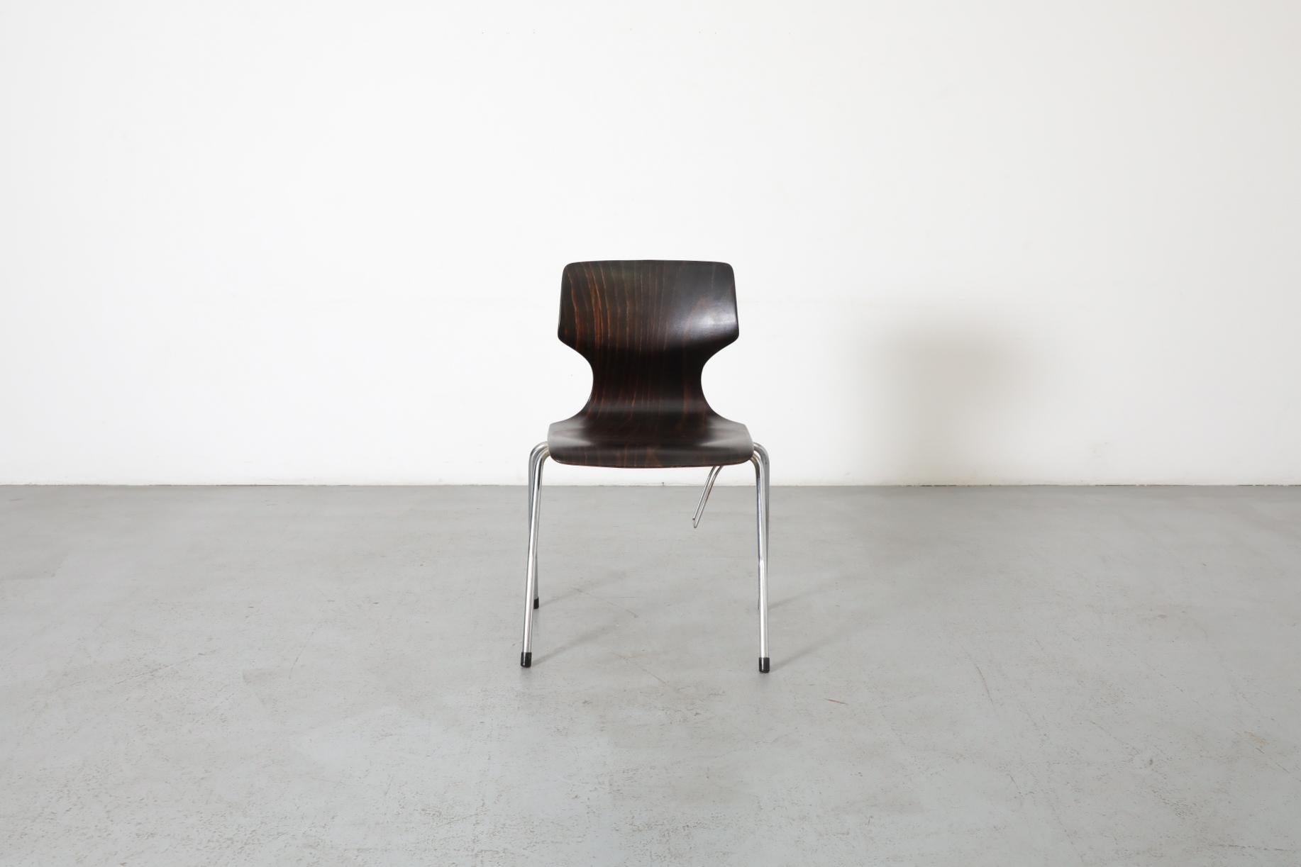 Pagholz Flötotto wenge toned wingback stacking chair, 1970's. Beautiful streamlined smart design. Shown with Gispen brown enameled metal desk with teak top (LU922443241852). In original condition with visible wear consistent with its age and use.