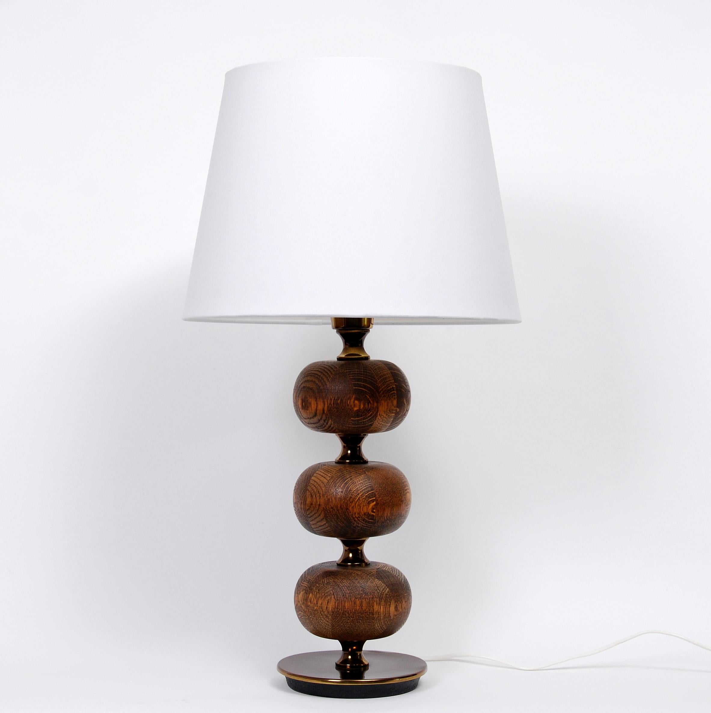 Rare table lamp designed by Henrik Blomqvist for Stilarmatur in Trana°s,Sweden. Featuring a dark brass base with three spheres in solid wenge wood. Please note: We’re selling this table lamp without the shade. Newly rewired.

 