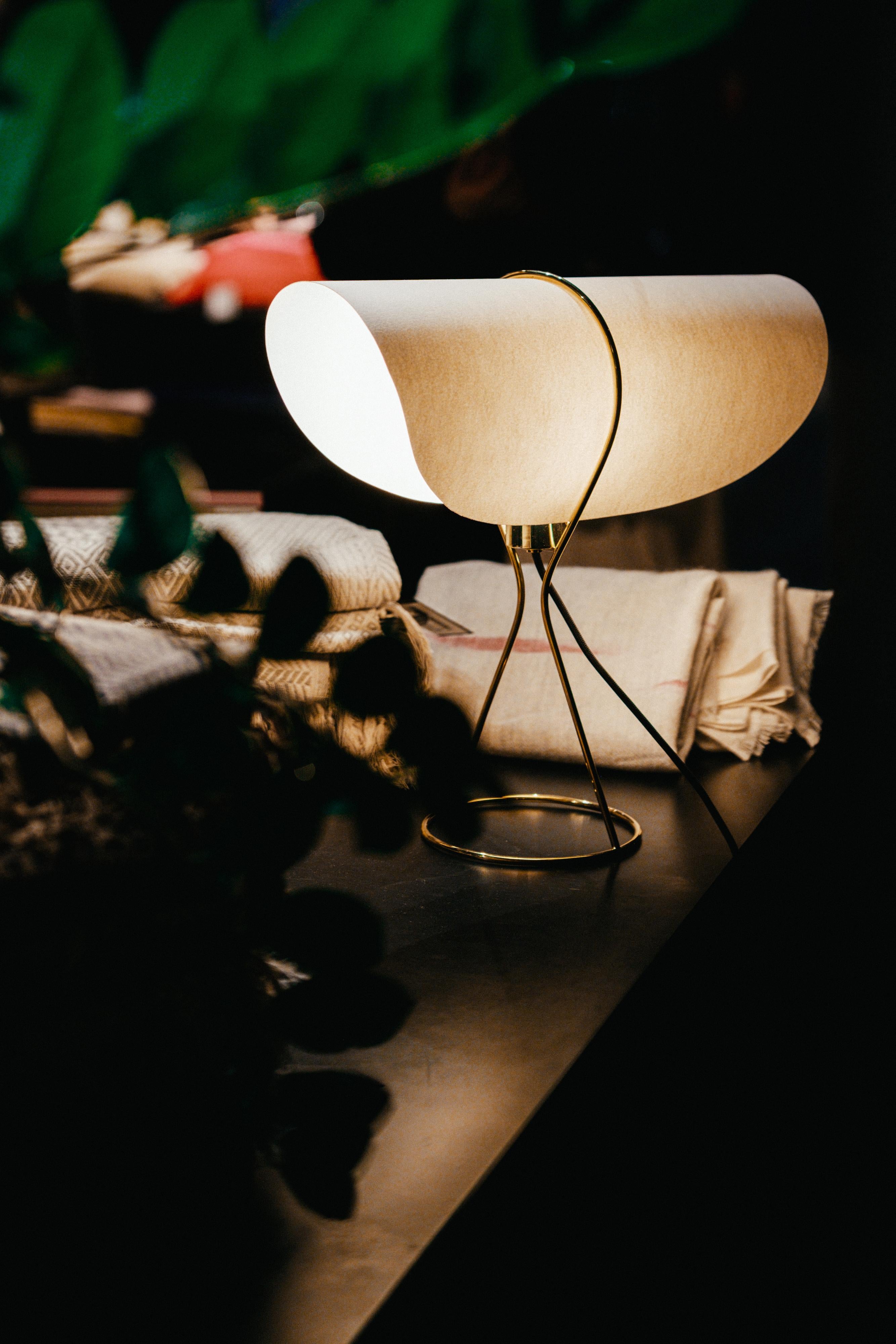 Werkstätte Carl Auböck 'Nun' table lamp. Designed in 1950, this versatile and Minimalist Viennese lamp is executed in brass with a cast iron base and sculptural hard paper shade by Werkstätte Carl Auböck, Austria.

Price is per item. Other shade