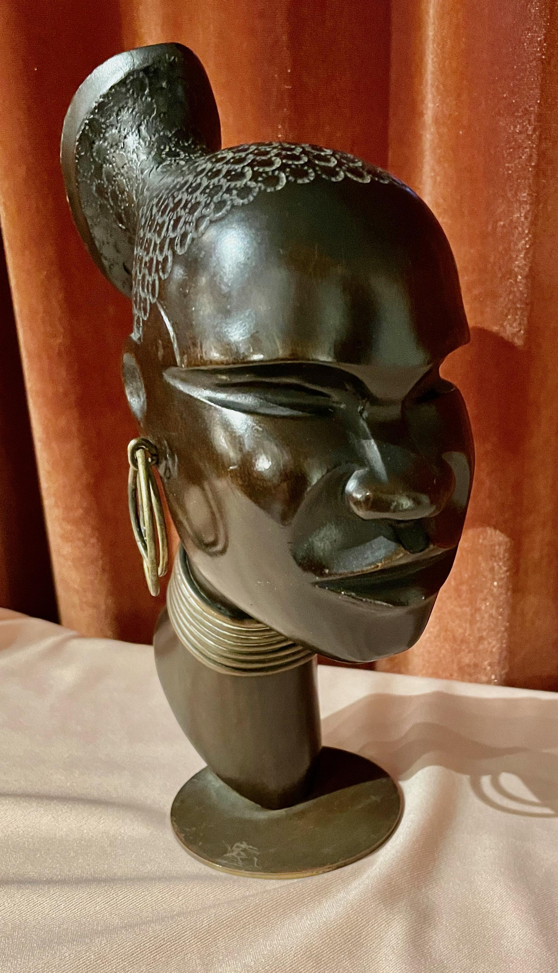 Hagenauer wood sculpture Head of African Woman. This beautiful sculpture was designed and manufactured by Hagenauer in Vienna in the 1930s during the Art Deco era. It shows the head of an African warrior and is made of finely carved wood, with some