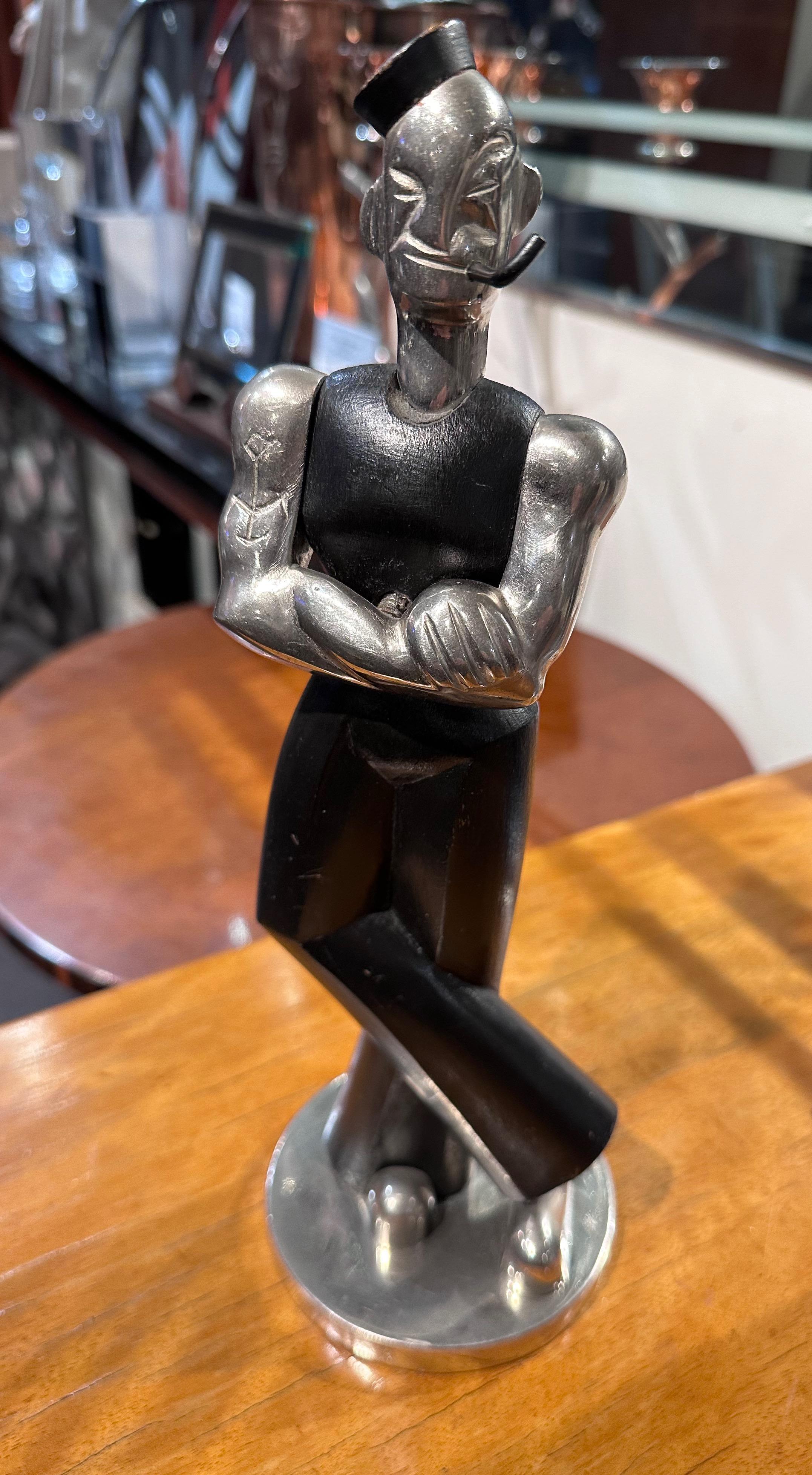 Popeye the Sailor is a European sculpture in the Hagenauer style made of Ebony wood and metal in the Art Deco style. We have had a few pieces in this treatment, including style and materials. They are scarce to find. This one is exciting since it is