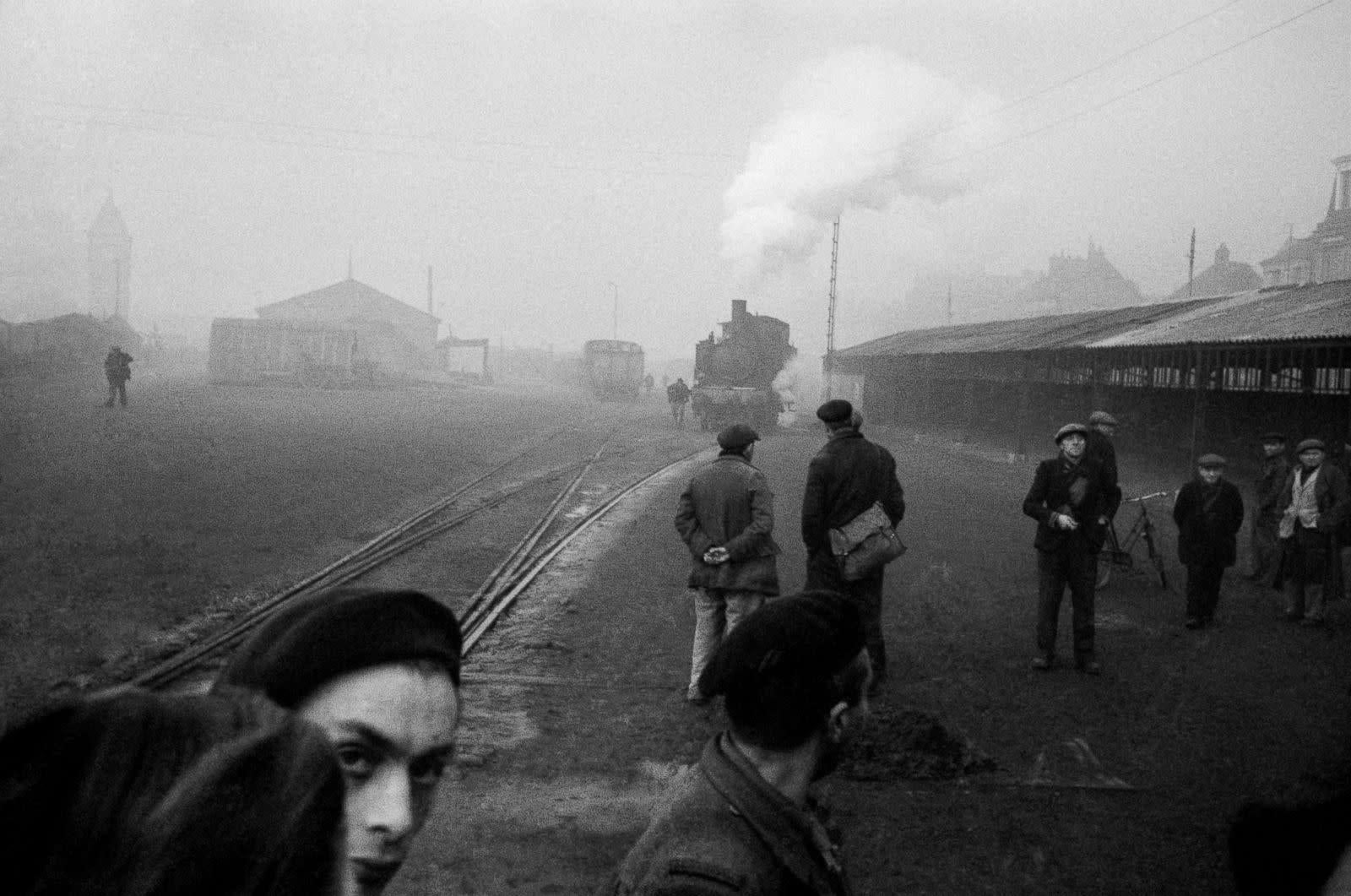 Werner Bischof Black and White Photograph - Unemployed People Look for Jobs at the Railroad Station, City of Rouen, France