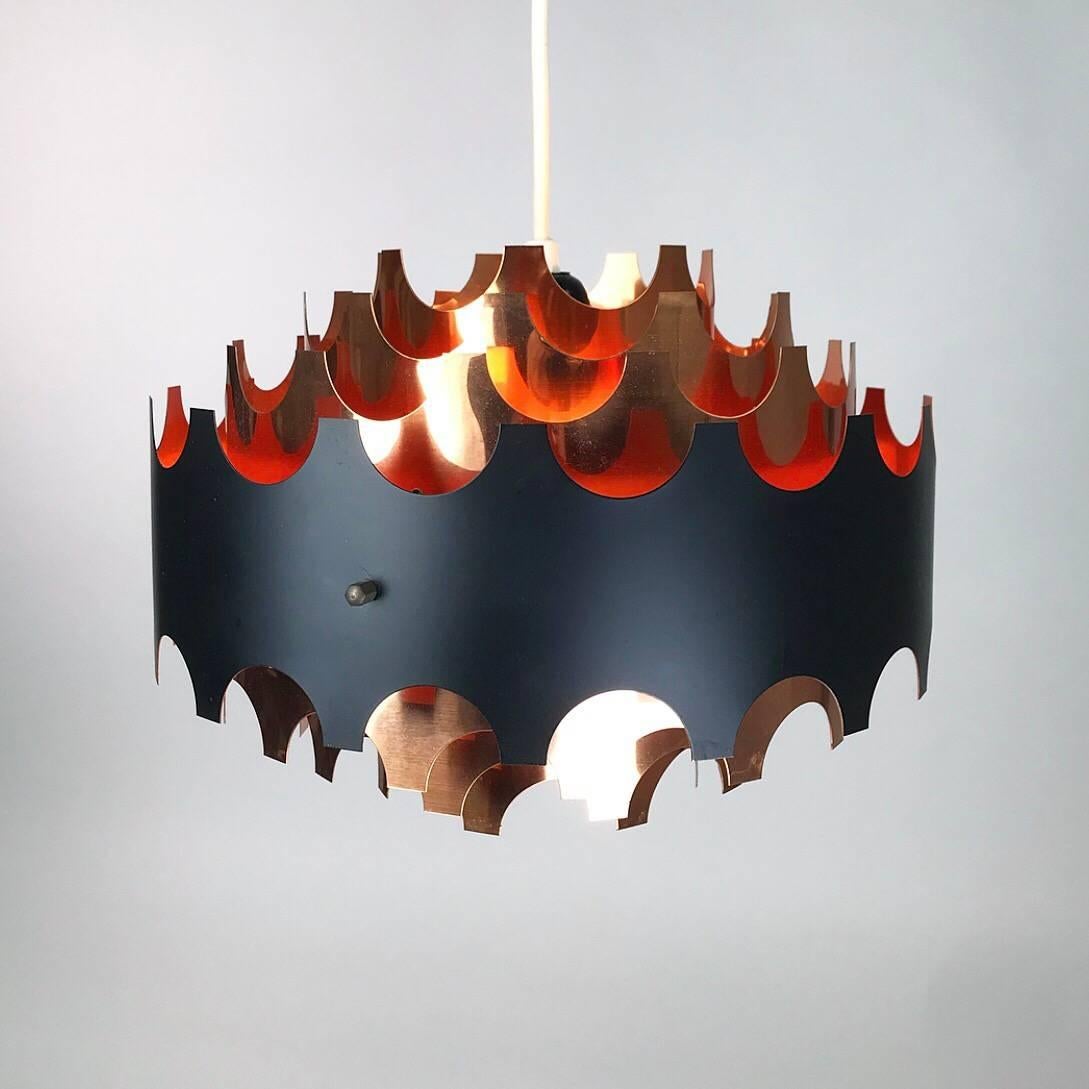 Not less than nine shades is what this stunning copper light is made of. 

All copper with the outer rim in black and orange lacquer. 

Most have been in some sort of time capsule since traces of wear in down to almost nothing.

Light source: