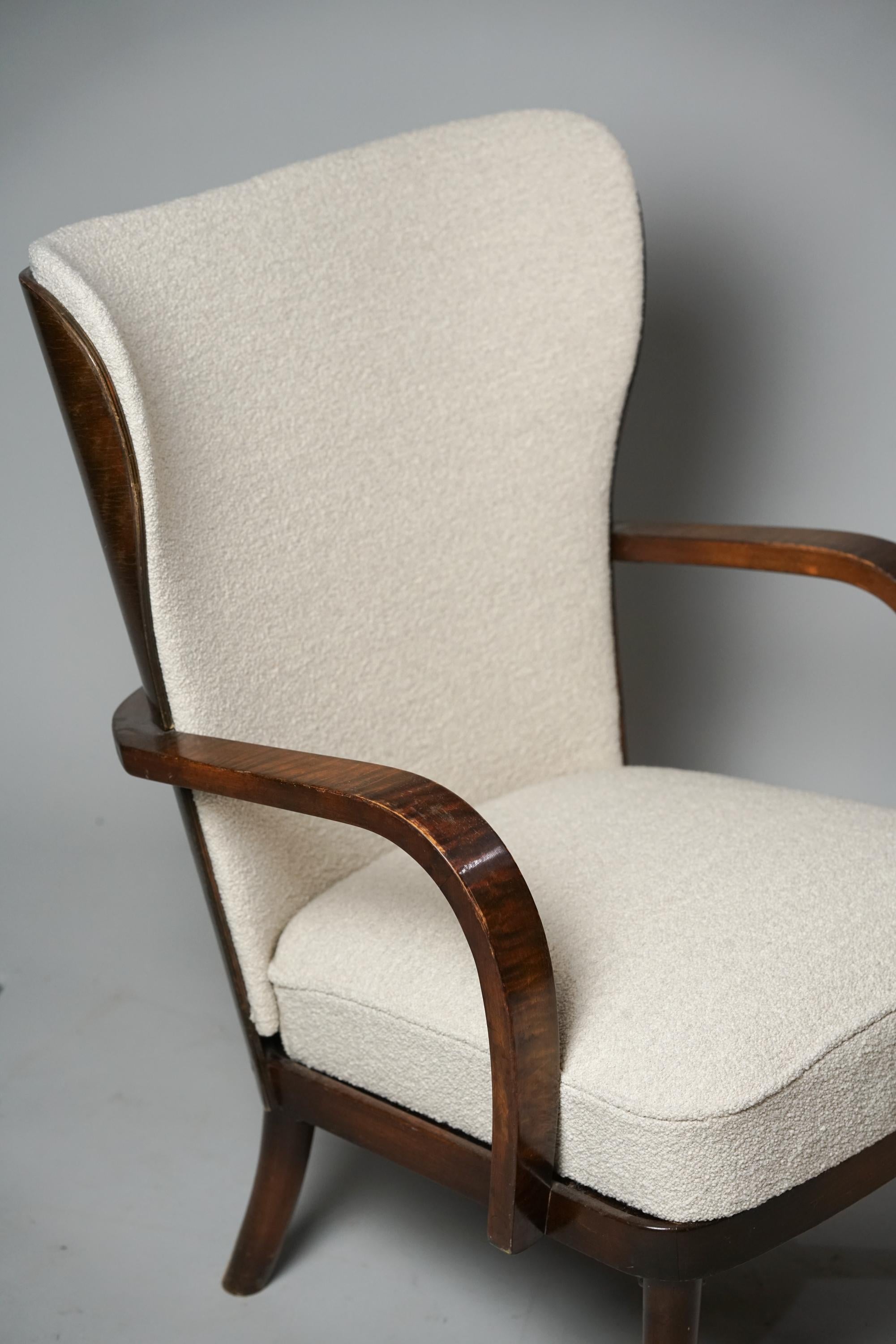 Wingback chair, designed by Werner West, manufactured by Wilhelm Schauman, 1930s. Stained birch frame, reupholstered with quality Lauritzon's Orsetto 012- fabric. Good vintage condition, minor patina consistent with age and use. Gorgeous
