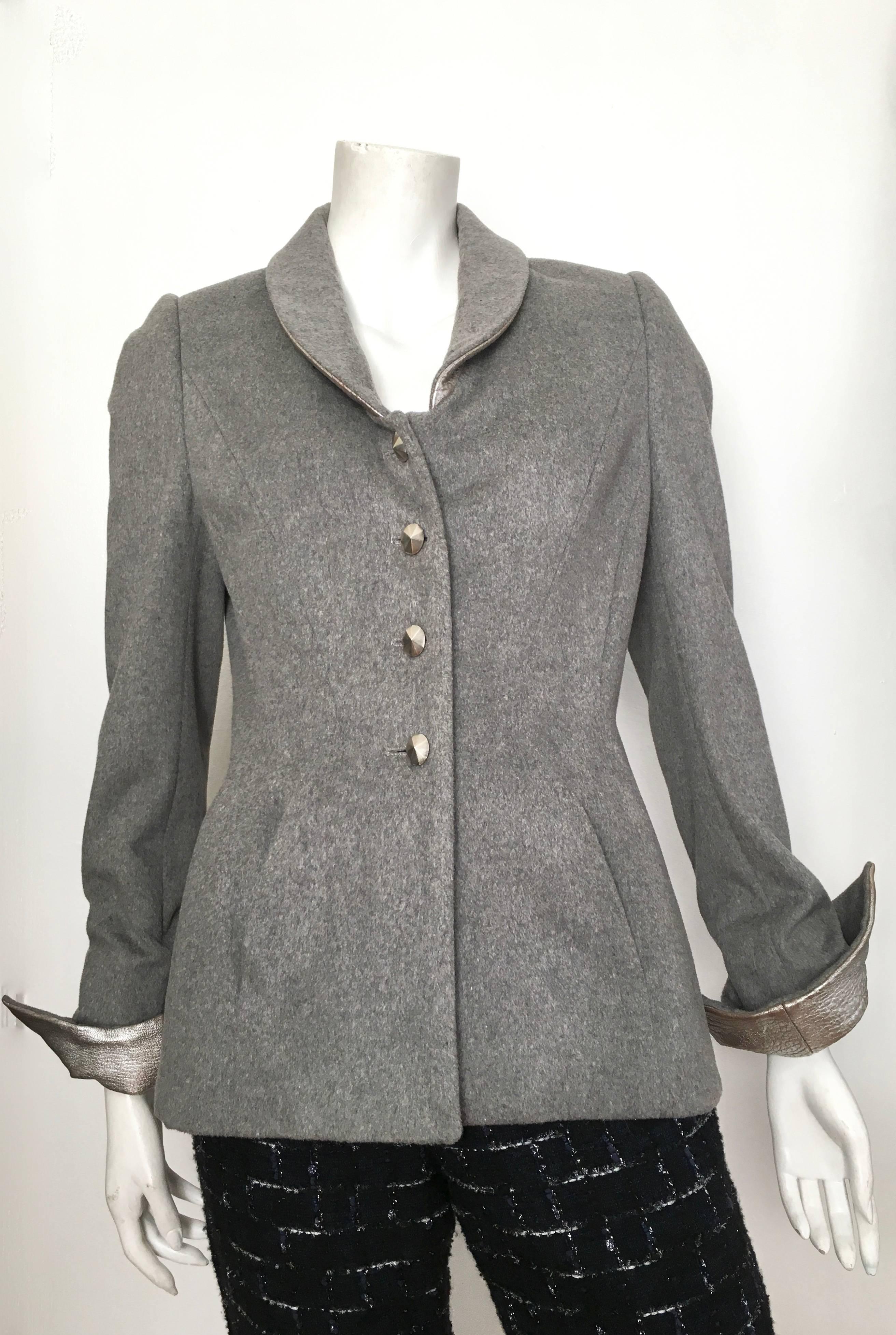 Wes Gordon grey wool & cashmere jacket with silver lambskin collar & cuffs with navy boucle pants is a size 8. Jacket has front curved pockets with amazing pleats on the backside of jacket. There are four silver faceted buttons on jacket. Pants have