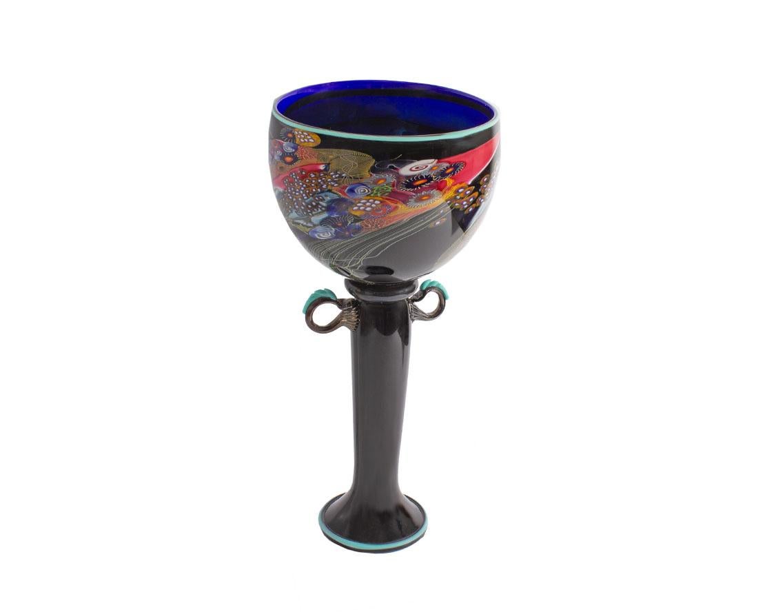 An art glass compote vessel by the American glass artist Wes Hunting (born 1958). From his Colorfield series, the vessel is made from a dark blue and purple glass and has a bowl at the top attached to a long slender stem with two handles on either