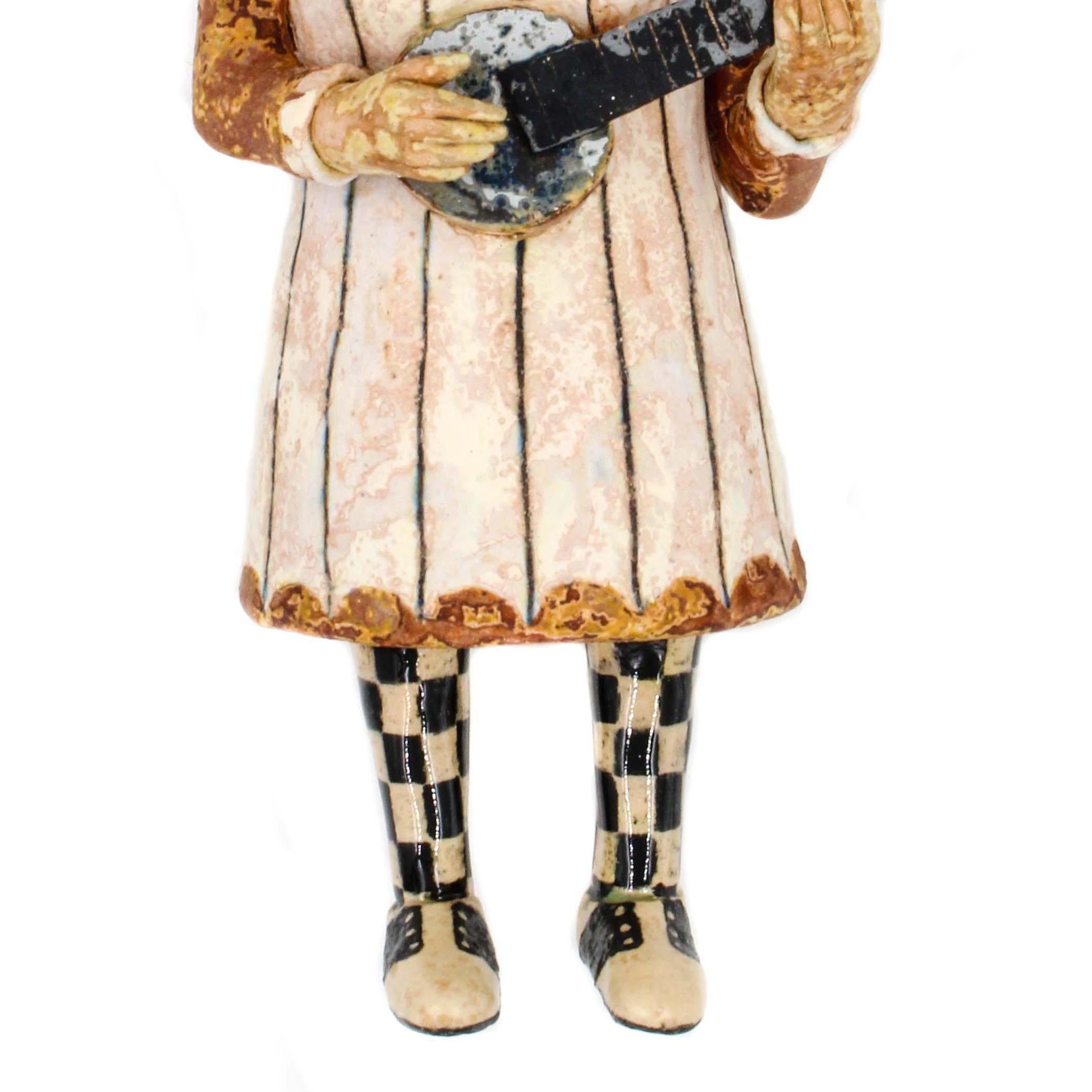 Banjo Lady is a 2018 ceramic earthenware scultpure by Wesley Anderegg. Banjo Lady is stamped by the artist with their initials.