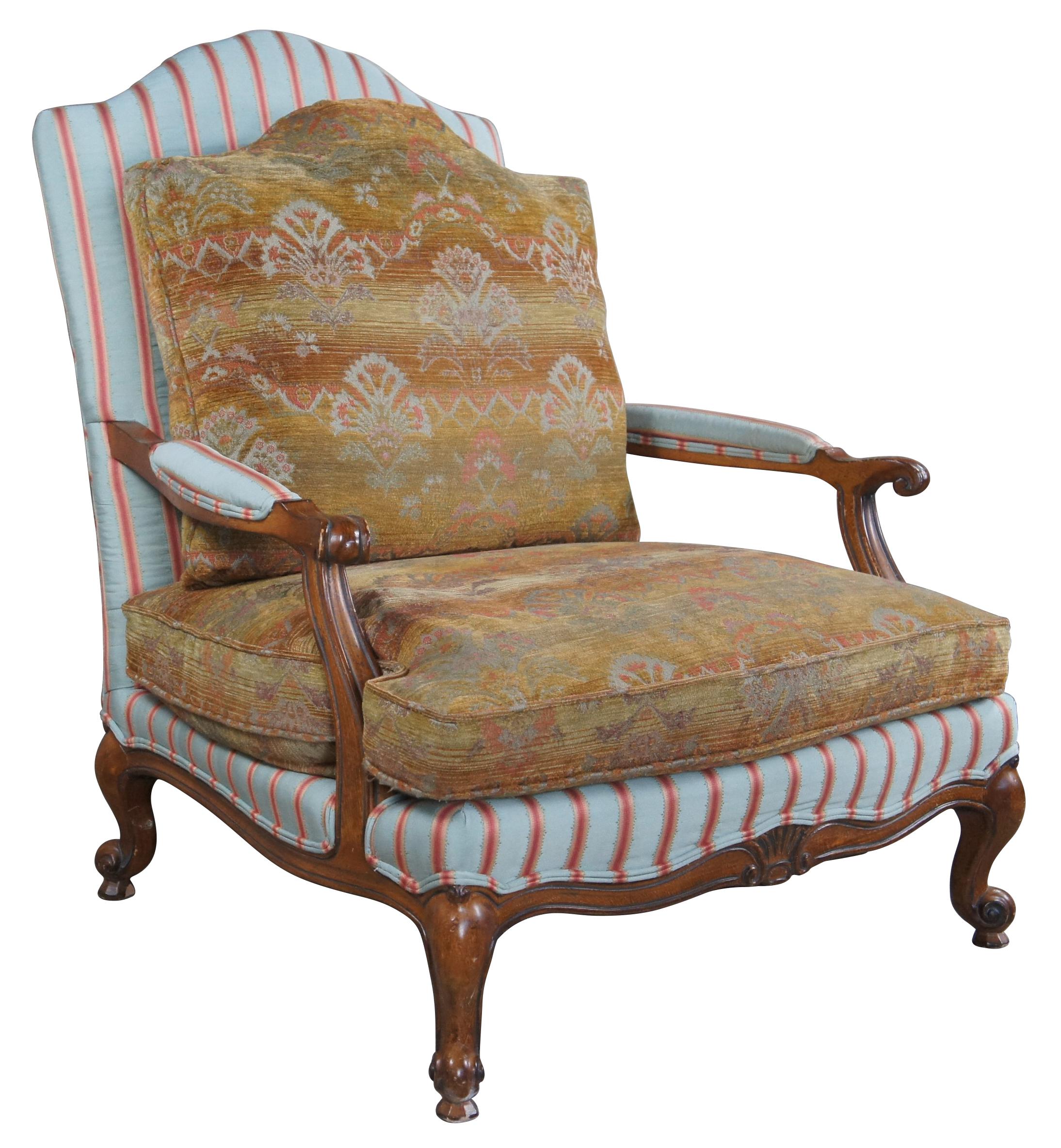 Vintage Wesley Hall oversized French Louis XV Bergere armchair. Features a serpentine oak frame with striped upholstery and southwestern cushions. The chair is supported by scrolled cabriole legs.