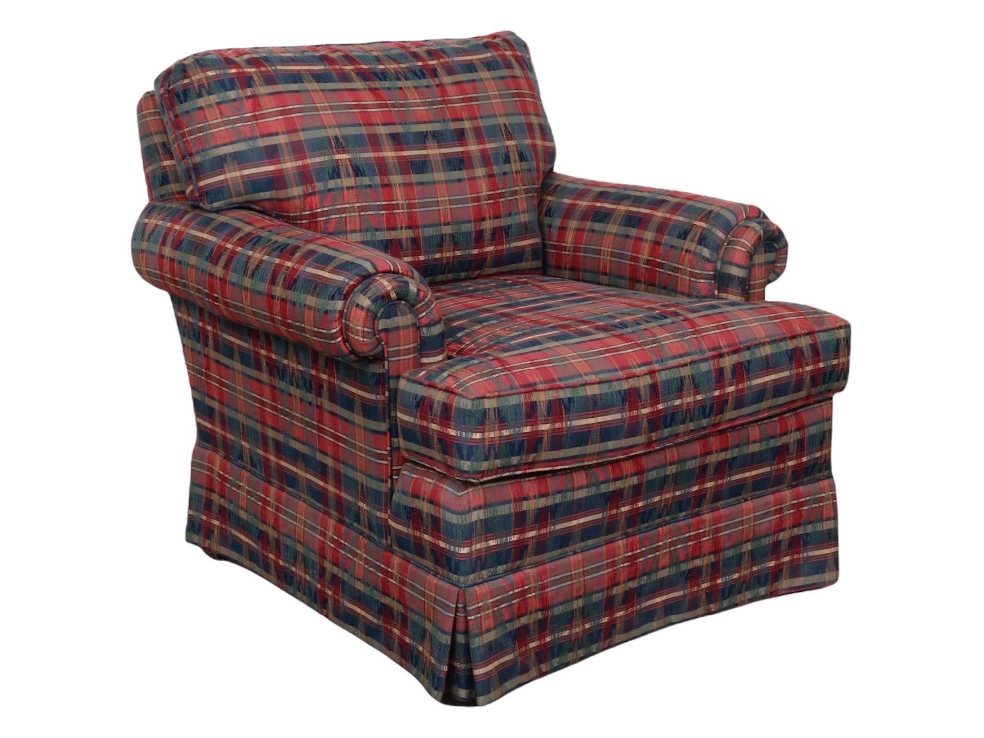 A transitional upholstered armchair made by Wesley Hall of Hickory, North Carolina. A square back and seat are framed with pad roll arms, upholstered throughout in a sophisticated two patterned jacquard fabric. A dominant red, navy and cream
