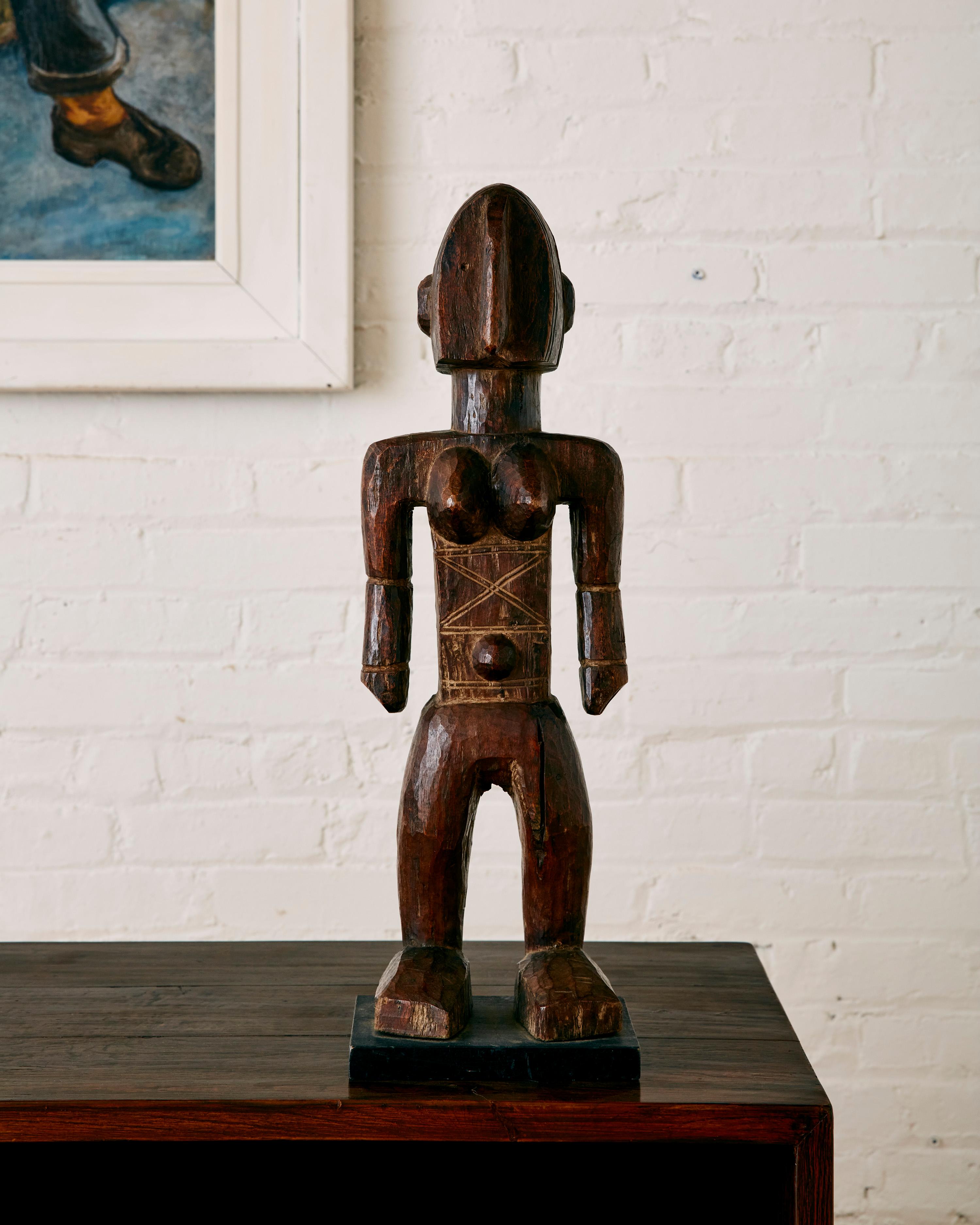 West African Bambara Sculpture depicting a Female Figure.

Bambara sculpture is primarily devoted to female figures. One important category is 'Nyeleni', small-scaled depictions of young women used in Jo society initiation performances. The figures