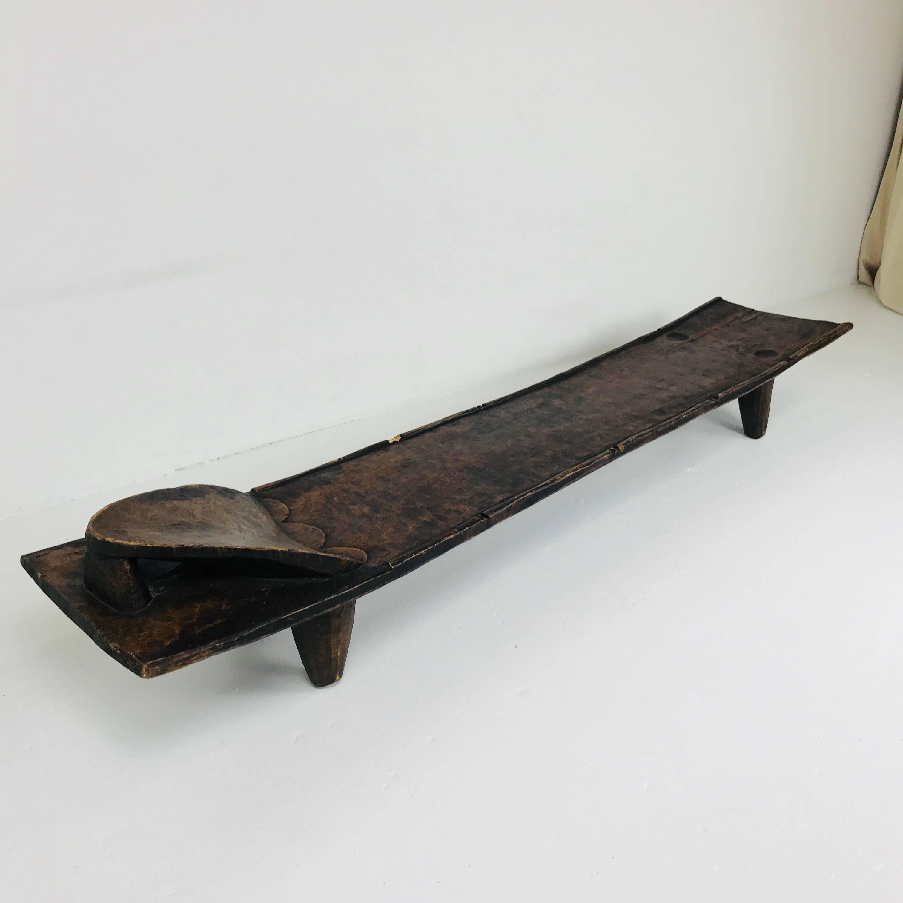 West African craved wood bed/bench by the Senufo Tribe. Craved from a solid piece of wood with minor loss but in overall good vintage condition.

Dimensions: 94
