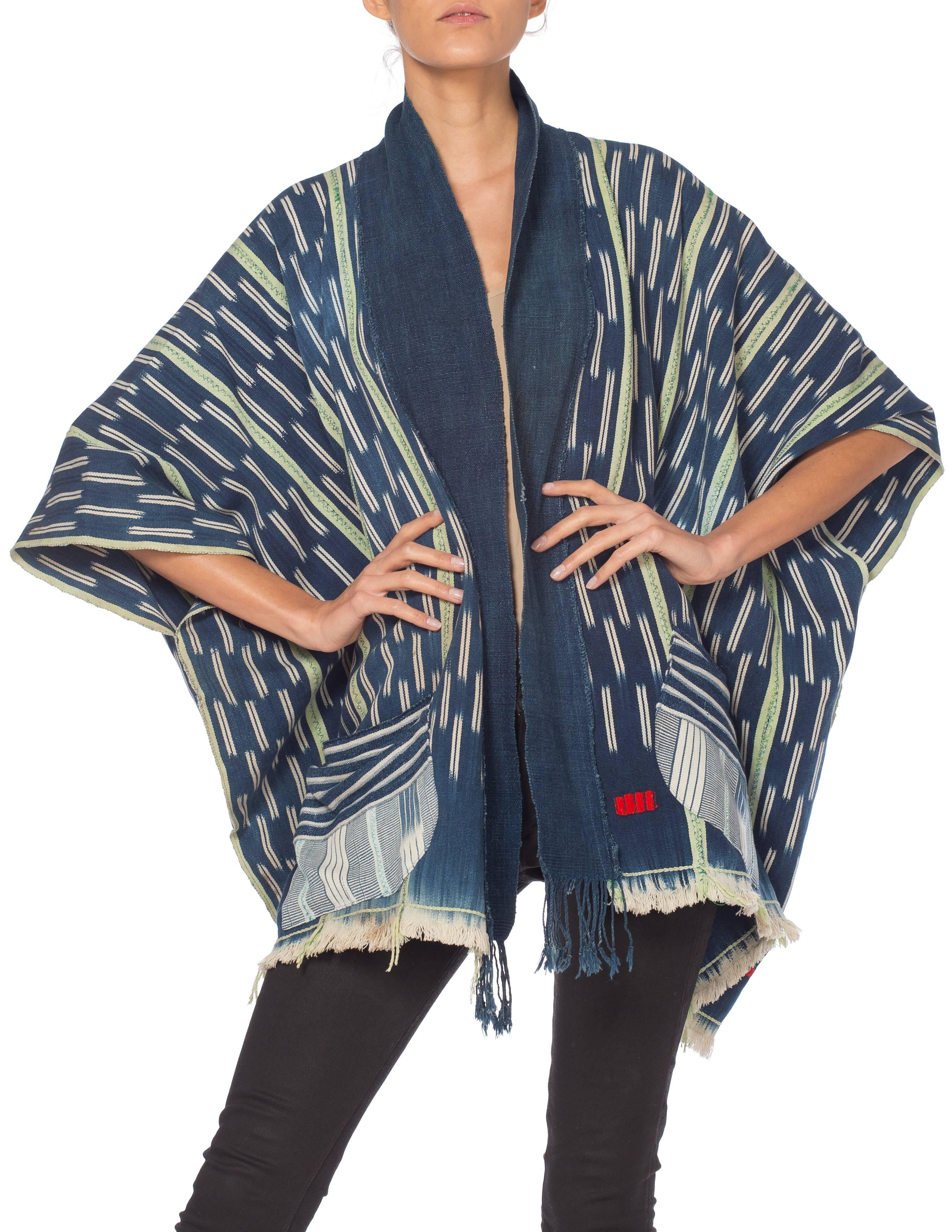 This piece is made from a hand woven and hand dyed 
West African cloth made by the Baule people of the Ivory Coast
The poncho shape of this garment honors the textile while making it wearabl MORPHEW COLLECTION Indigo Blue & Green Cotton Handwoven