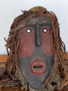 West African Mask from the Dan Tradition with Raffia and Pigmented Surface