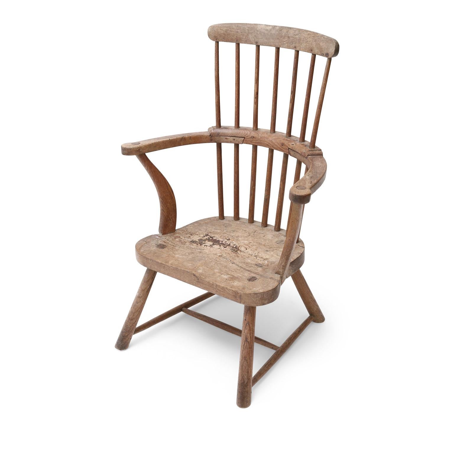 West Country vernacular Windsor armchair constructed (circa 1780-1810) from elm and oak in a comb back style. Nice thick plank seat. Perfect as a fireside chair.