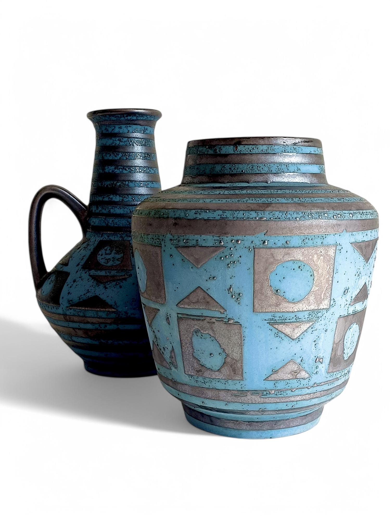 A beautiful and rare pair of Mid-Century Modern ceramic vases by Carstens Tönnieshof, designed by Helmut Scholtis. These pieces feature the highly sought-after Ankara décor in cyan blue and graphite grey with a satin matte finish. Handmade in West