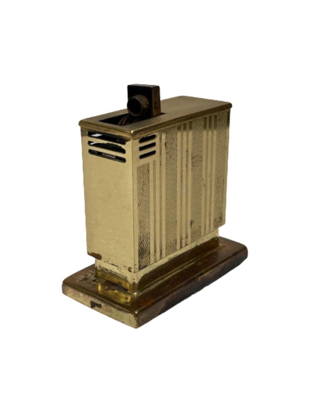 Original 1950 West German polished brass semi-auto table lighter by Augusta Lift Table Lighter Company. Simply pull up on the lighter and push back down to igniting the flame.

The lighter comes fully functional with fresh flit and fluid ready for