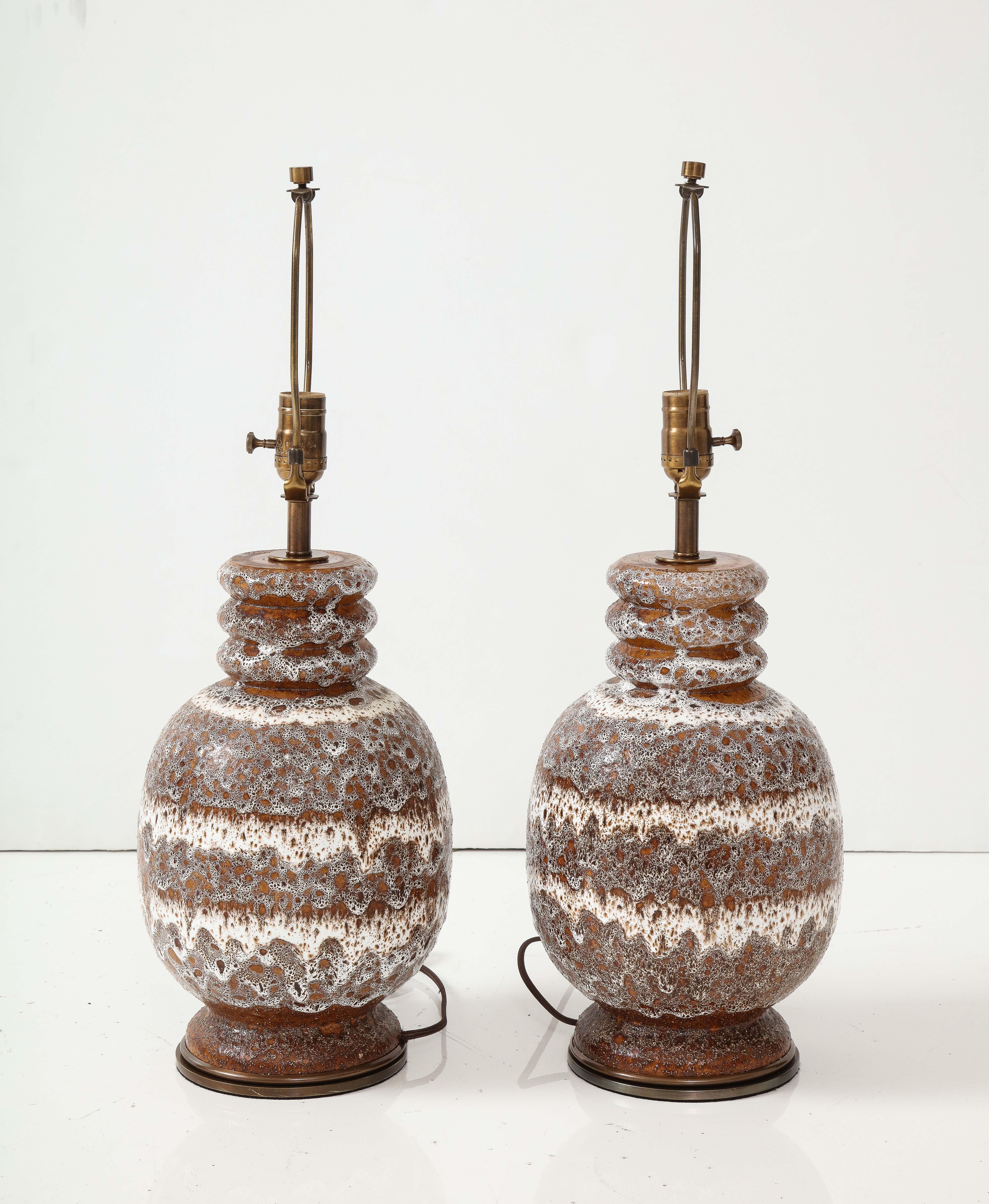 Pair of West German volcanic glazed ceramic lamps on aged bronze bases. Rewired for use in USA, 100W max bulbs.