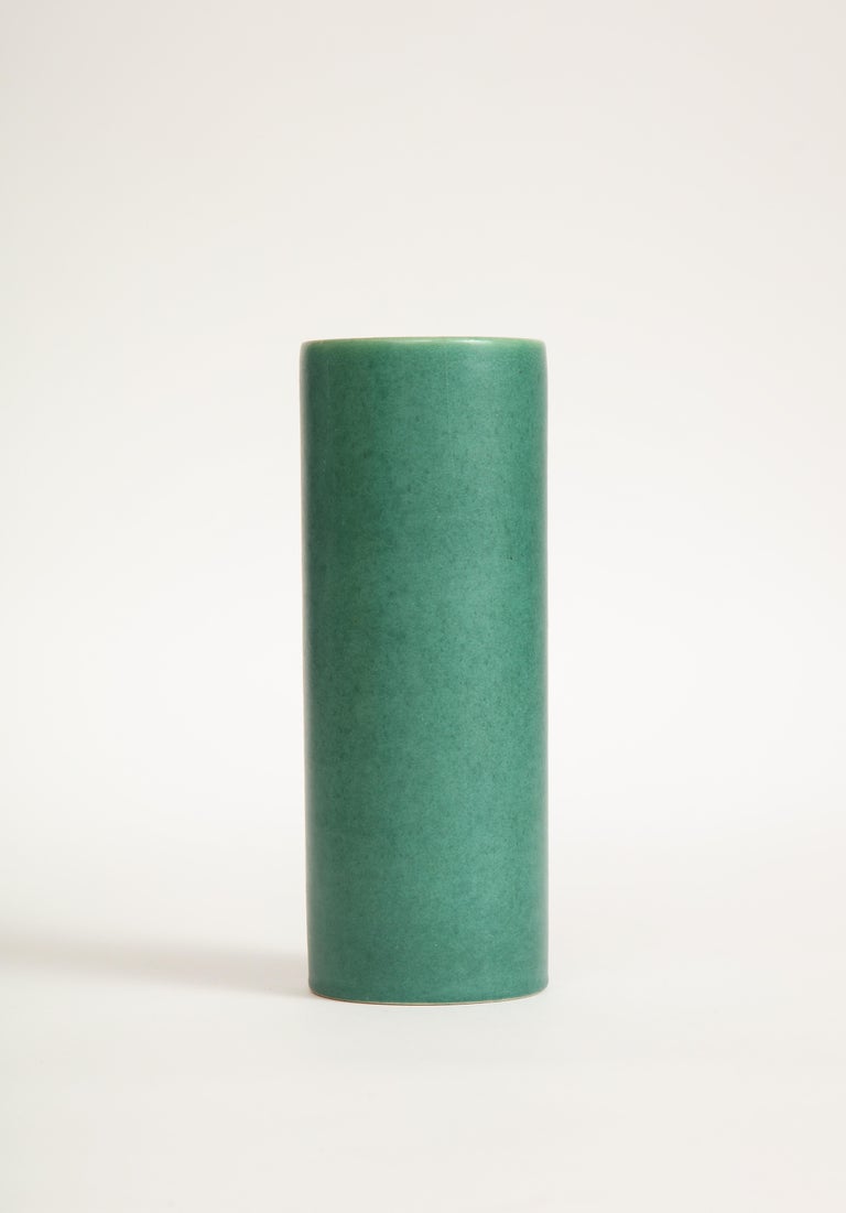 Tall, cylindrical, green ceramic vase. Marked.